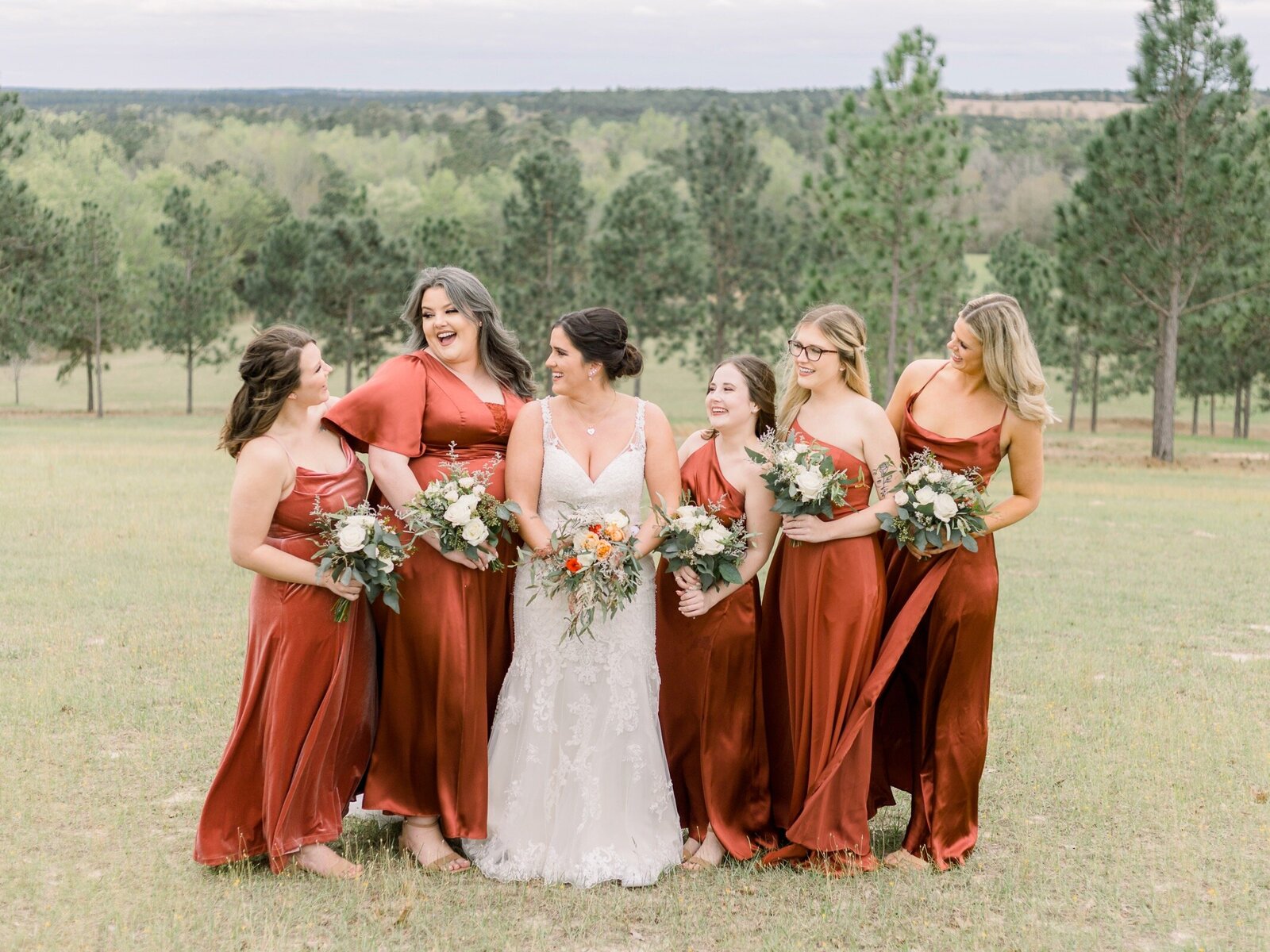 Bride and Bridesmaids laughing at each other