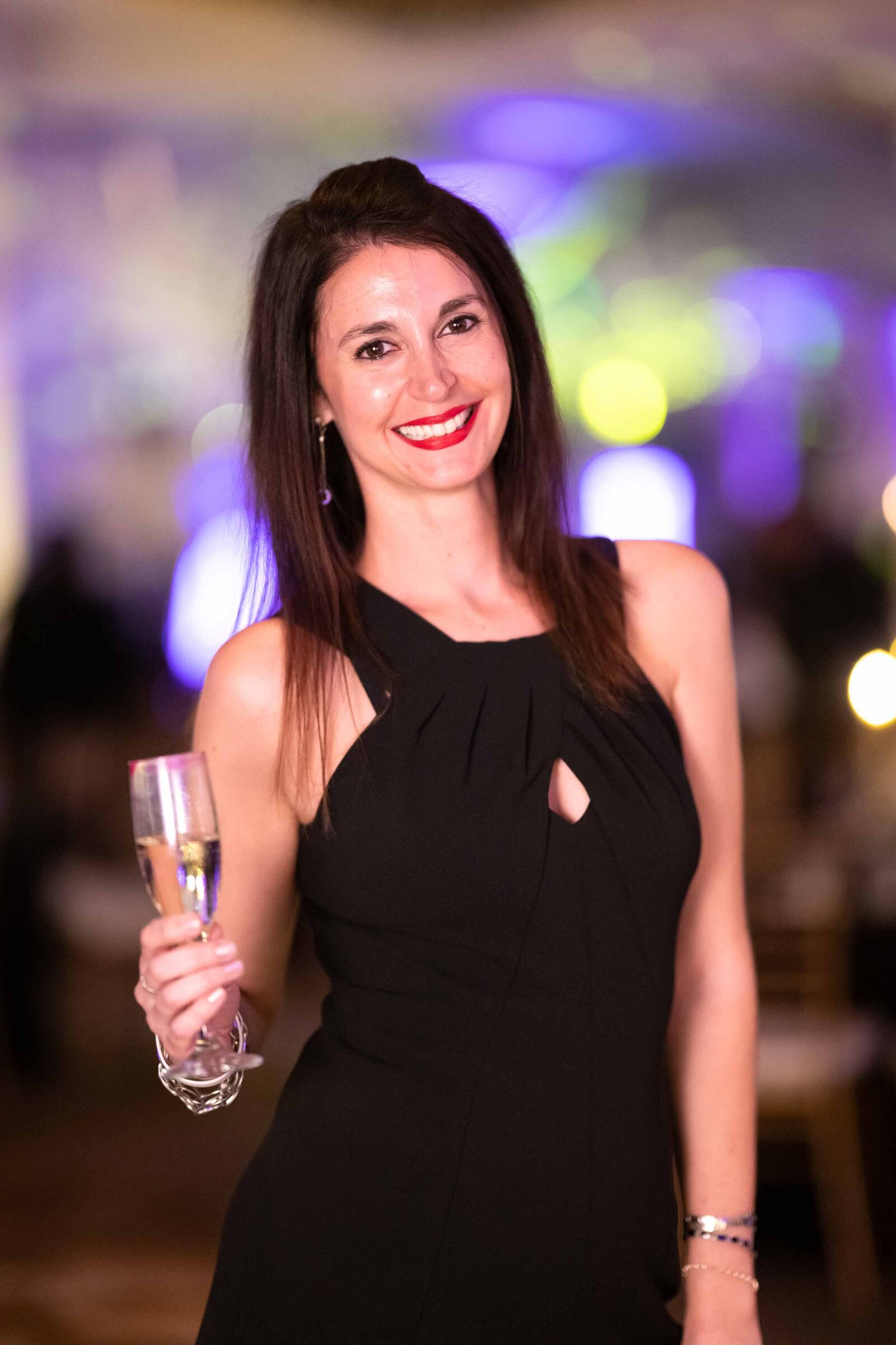 Holiday party woman smiling for the camera.-2023