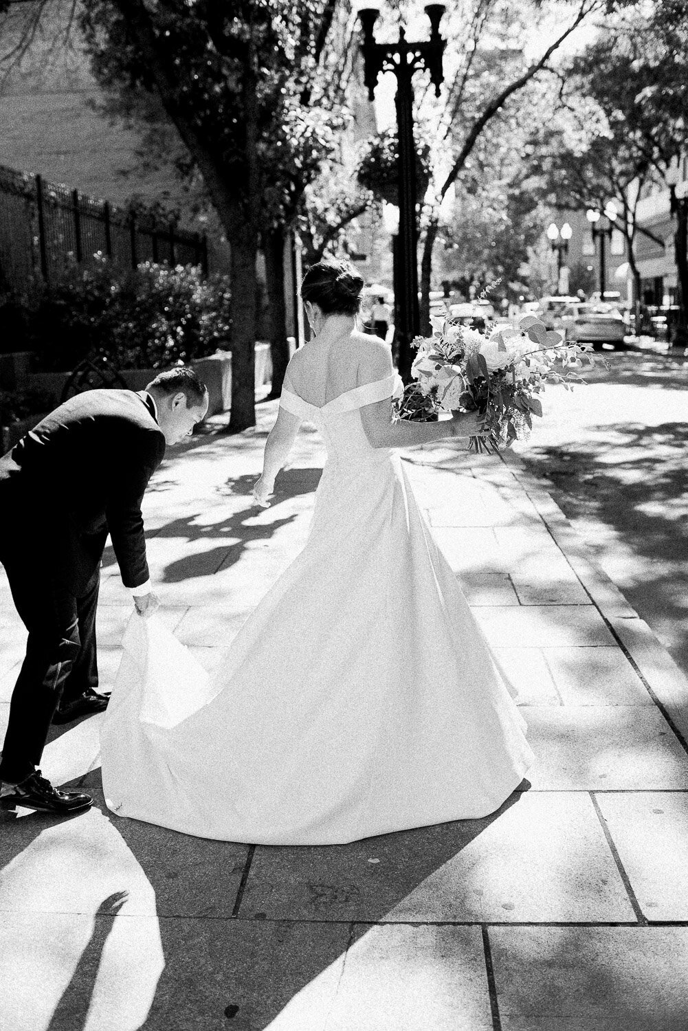 groom help bride with dress
