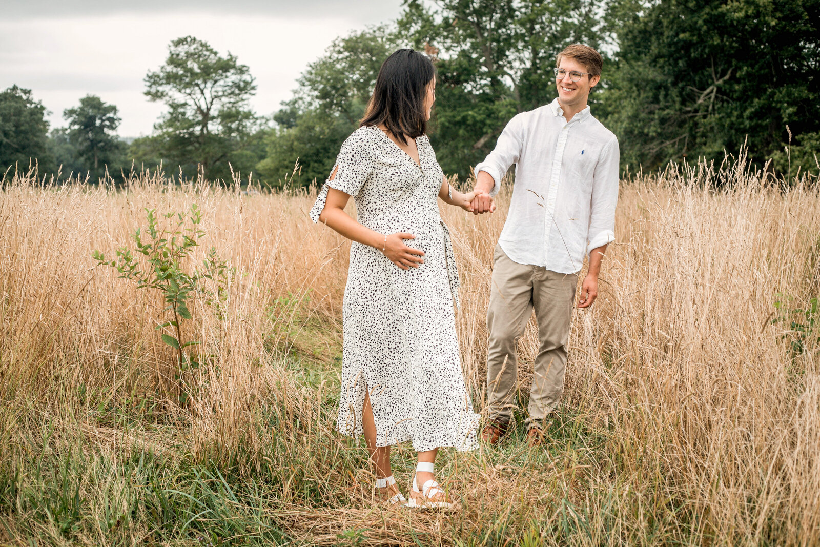 young couple walking through the field