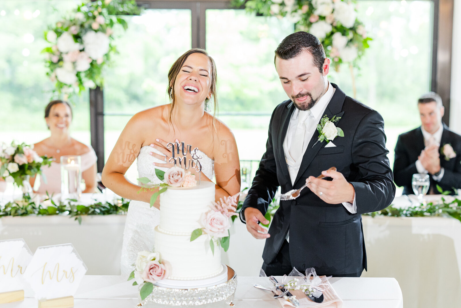19_dc_estate_winery_wedding_couple_smiling_during_cake_cutting