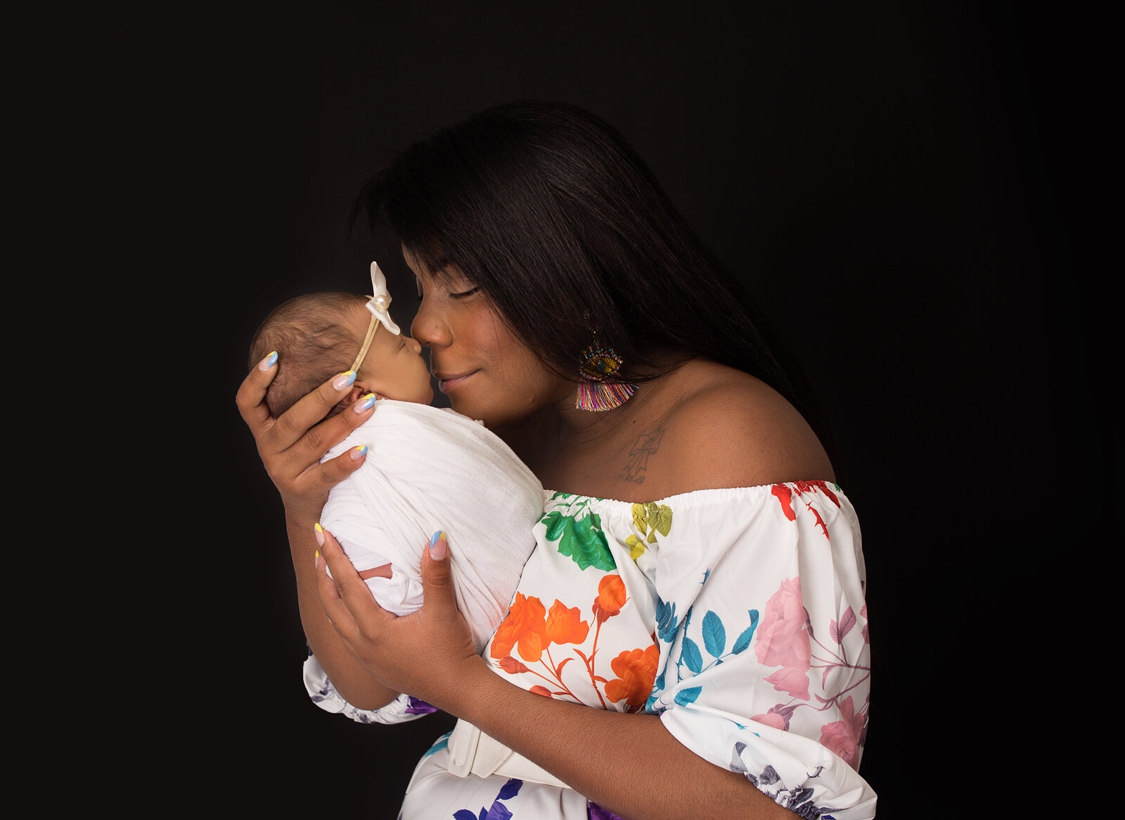 Mom holding baby girl to her face during newborn photoshoot with Nashville, TN Photographer in Nashville, TN Photography studio