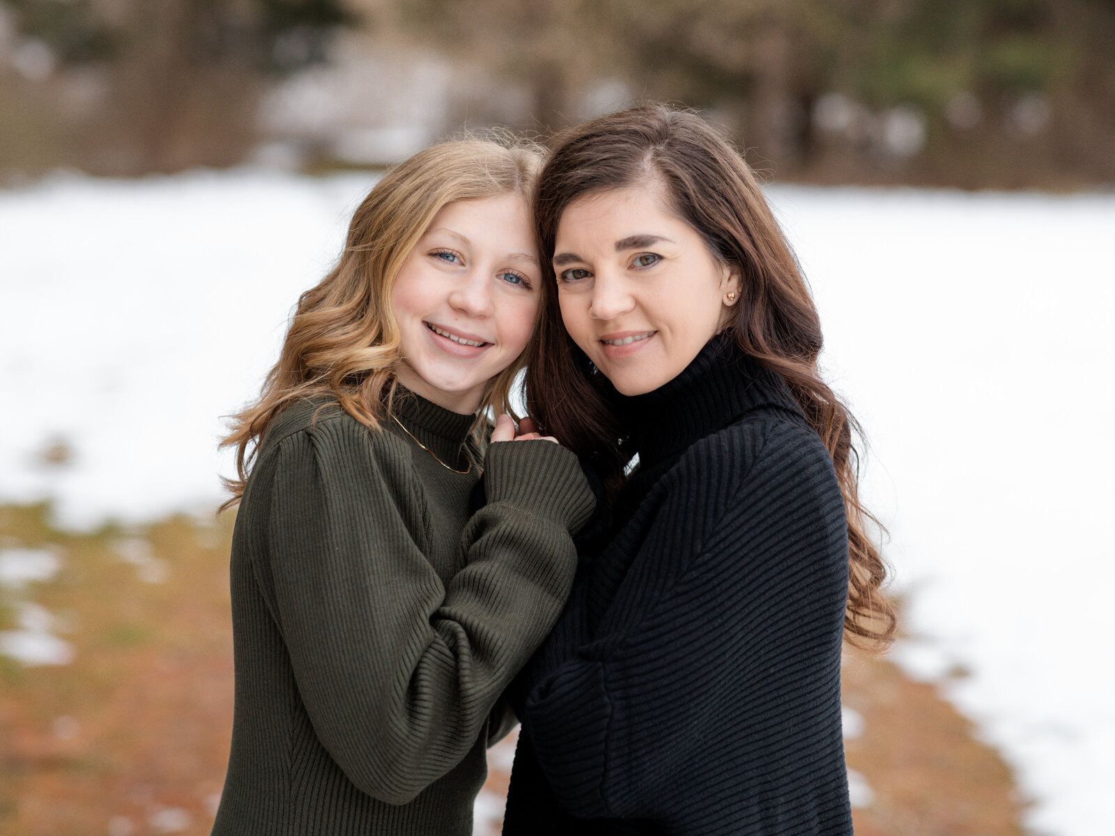 mother and daughter holding hands for family photoshoot at the park