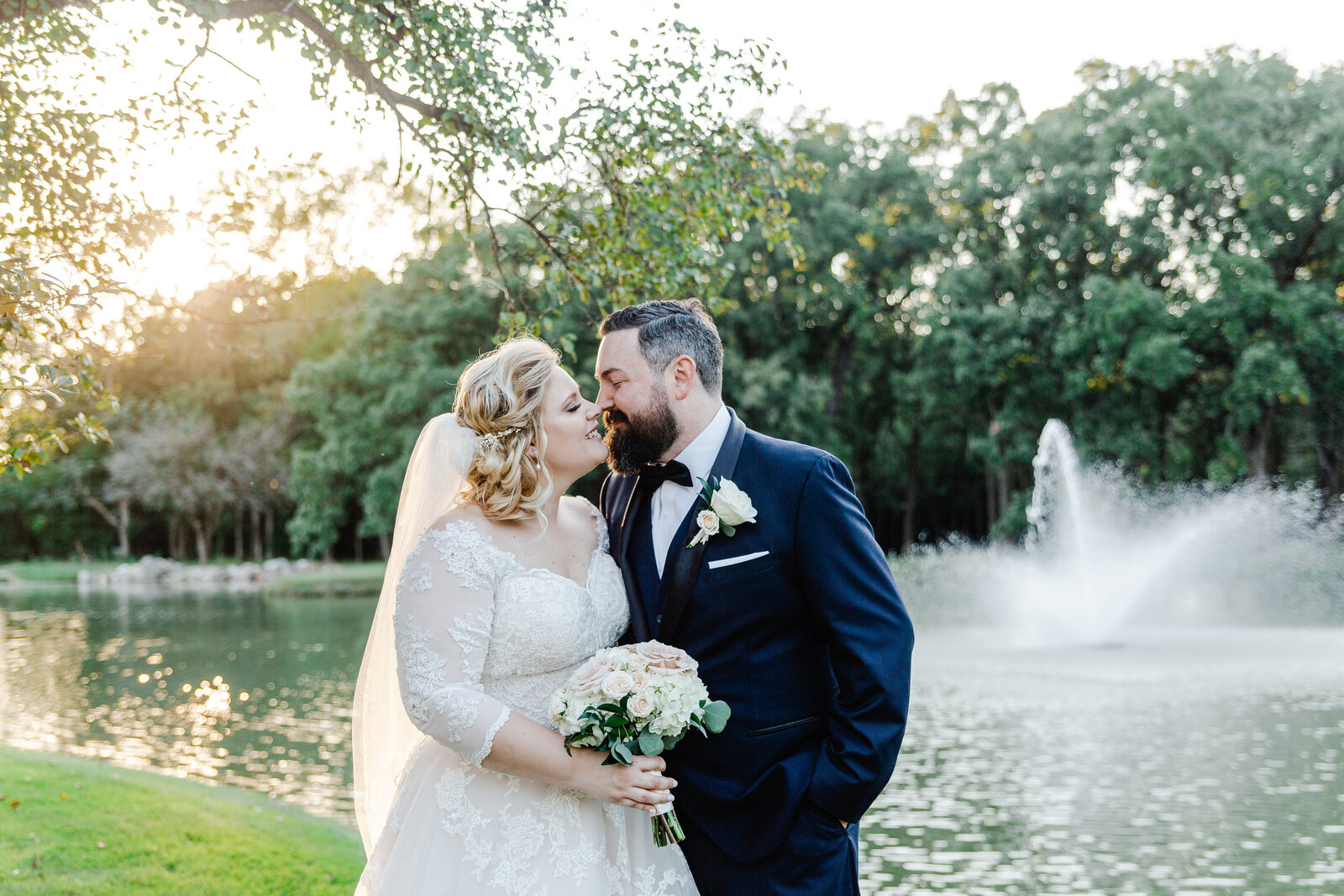 bride and groom kissing by the lake Chciago wedding photographer