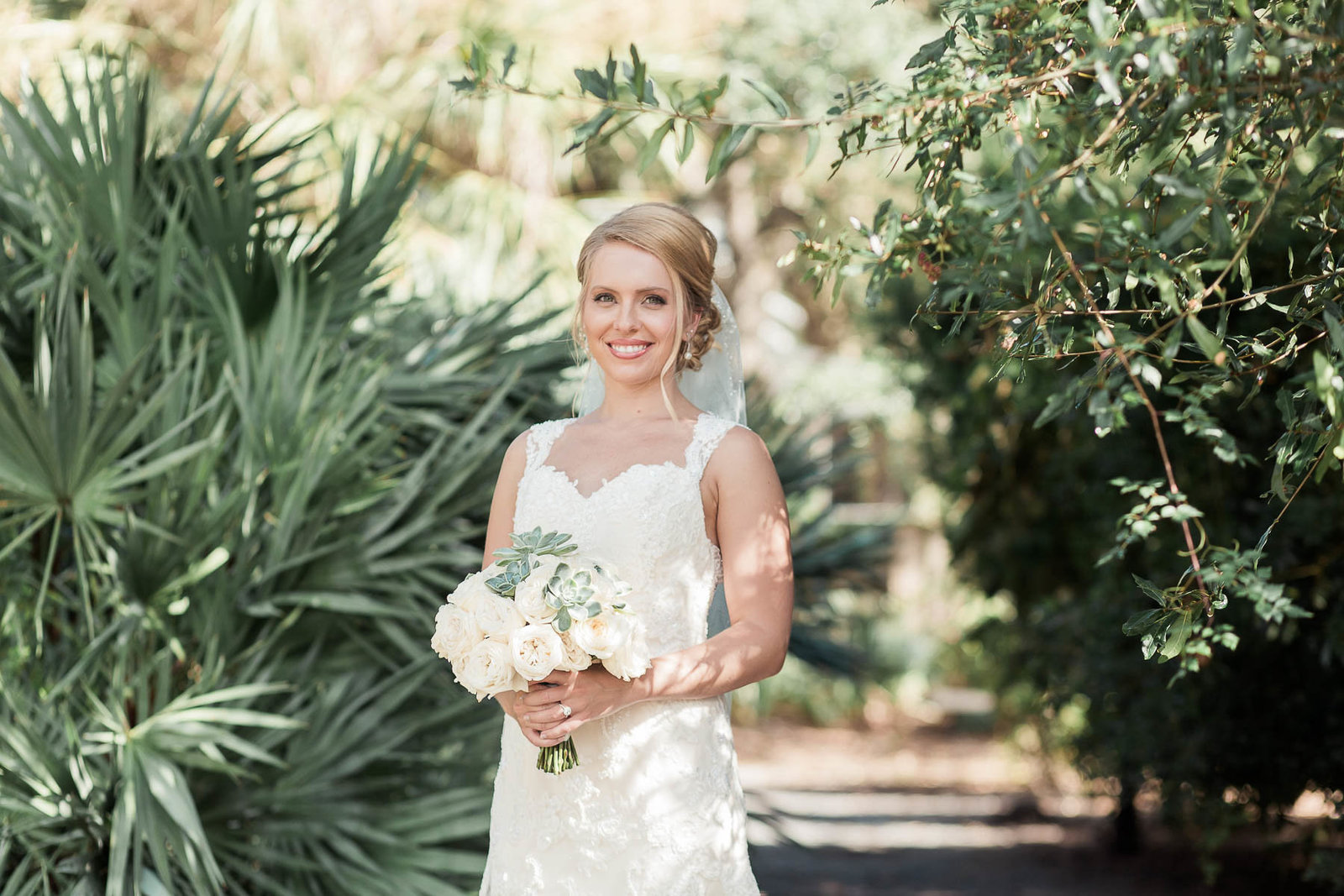 Bride stands by palm tree, Alhambra Hall, Mt Pleasant, South Carolina
