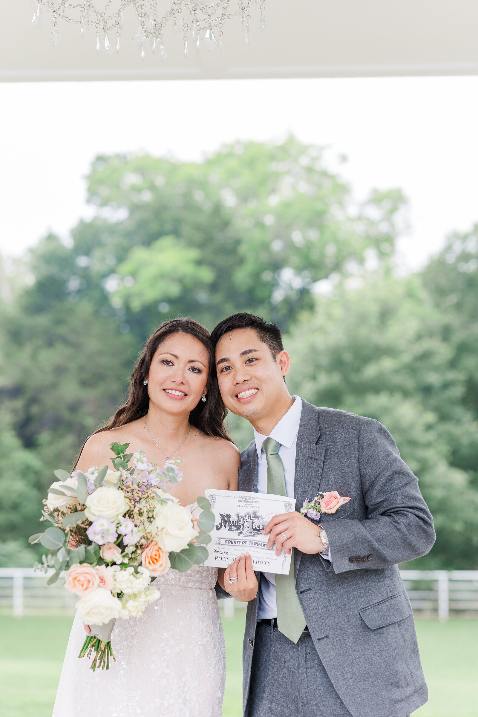 Bride and groom holding marriage certificate after wedding ceremony