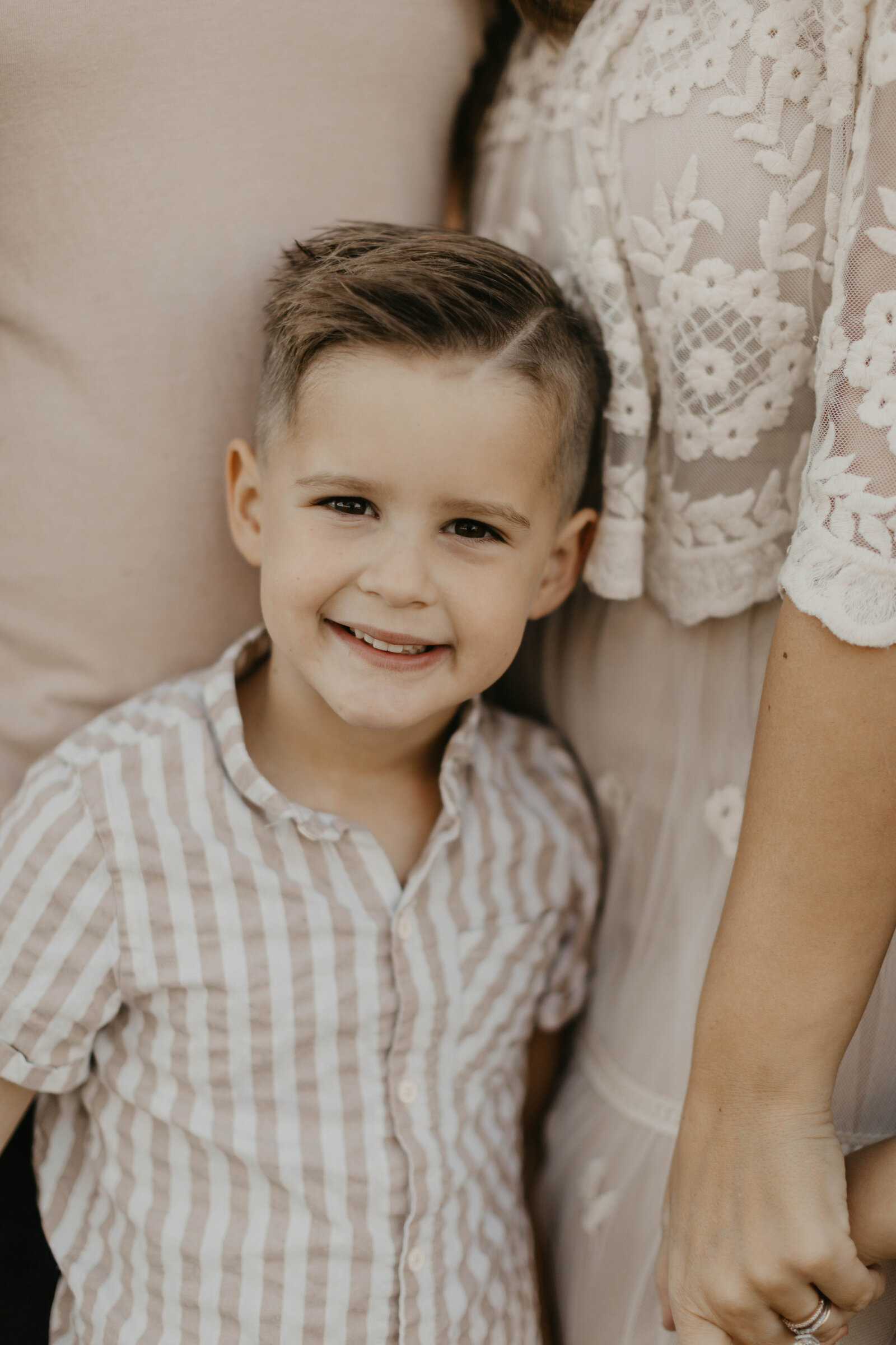 Little boy smiling at camera.