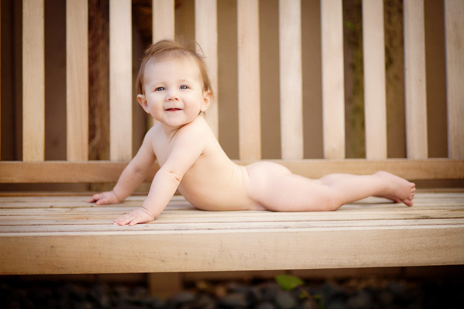 san diego family photography | baby with a big smile on a park bench outdoors
