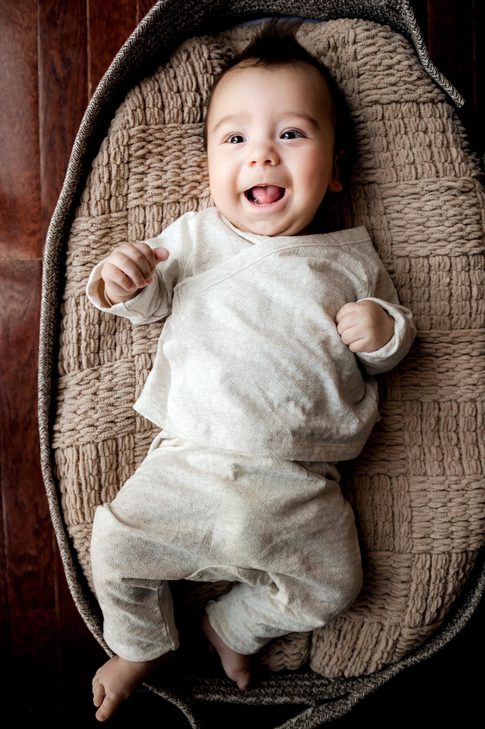 baby smiling in basket