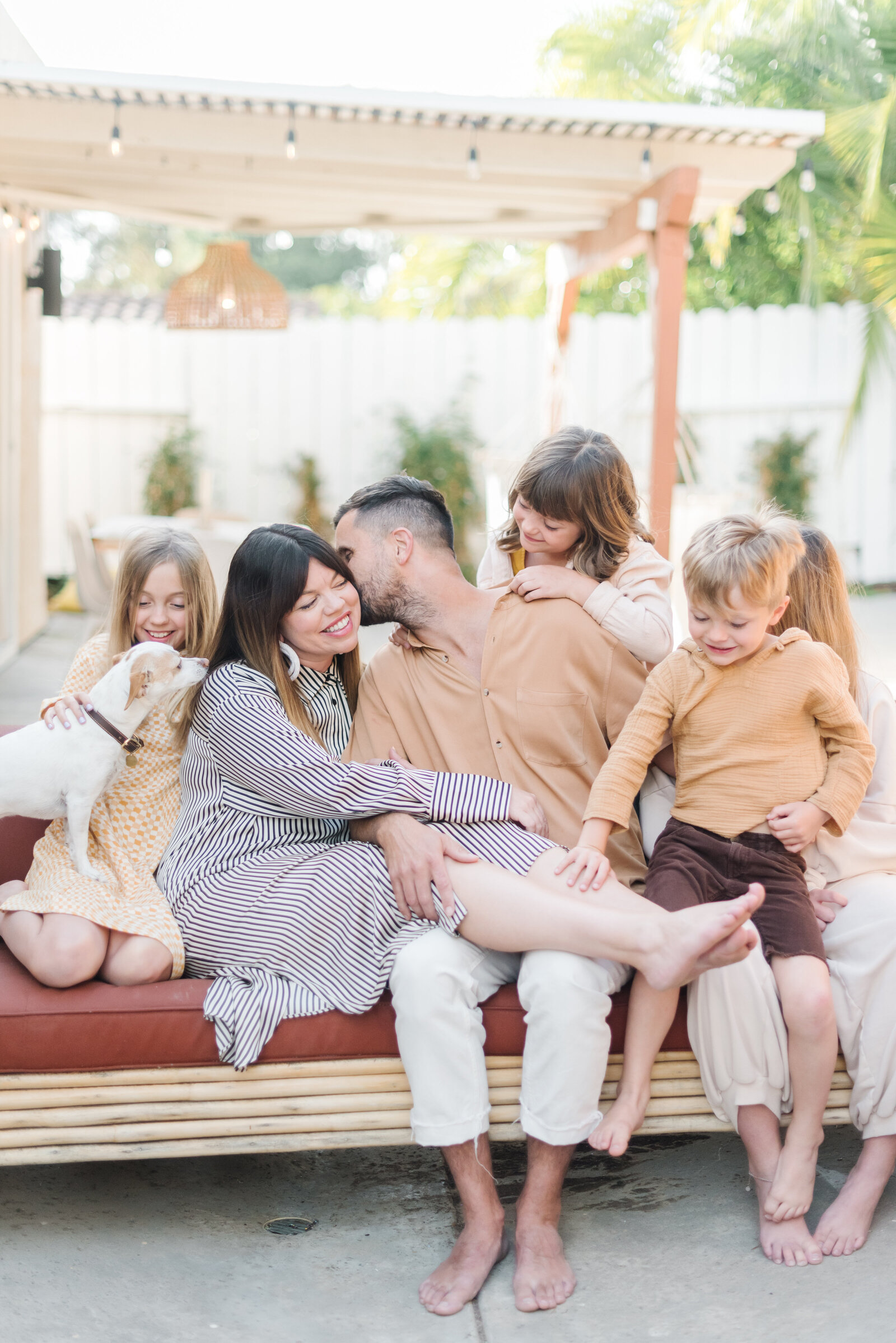Dad kissing mom on cheek surrounded by four kids and a dog - Virginia Family Photographer