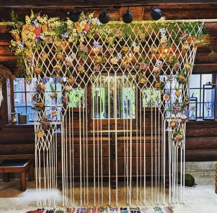 A macrame floral installation for a wedding at Loloma Lodge with flowers by Springfield florist Flowers & Thyme.