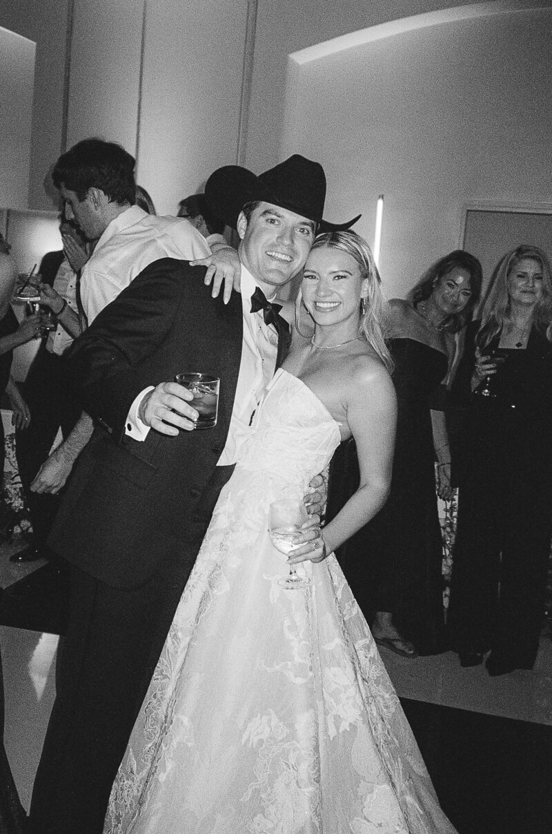bride and groom smiling and holding drinks at Fort Myers Wedding, photographed by Veronica Costa