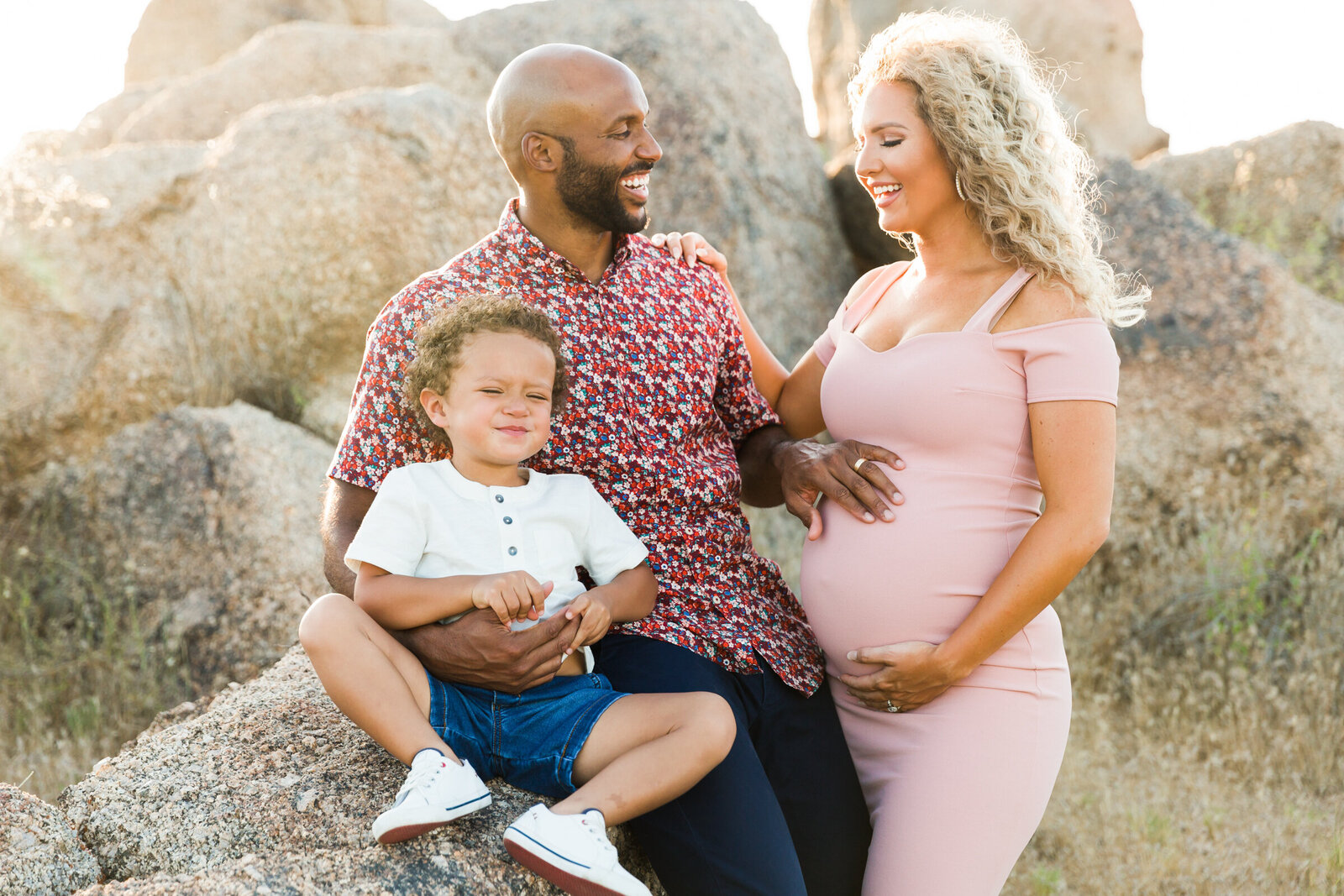 family holding baby bump in maternity photo