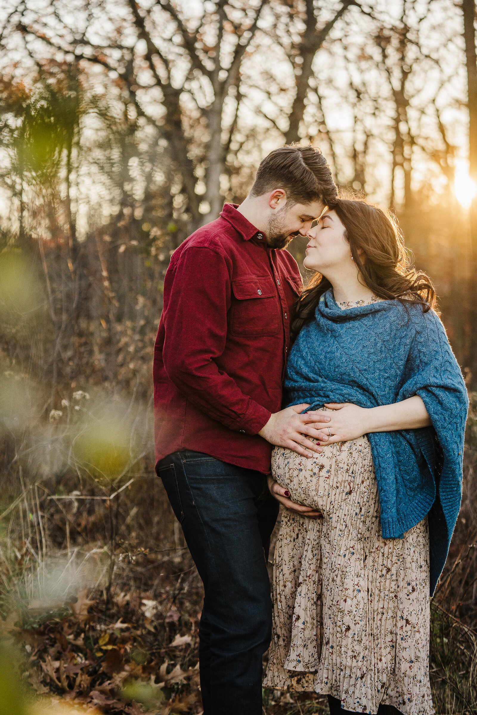 couple poses for maternity pictures in boston