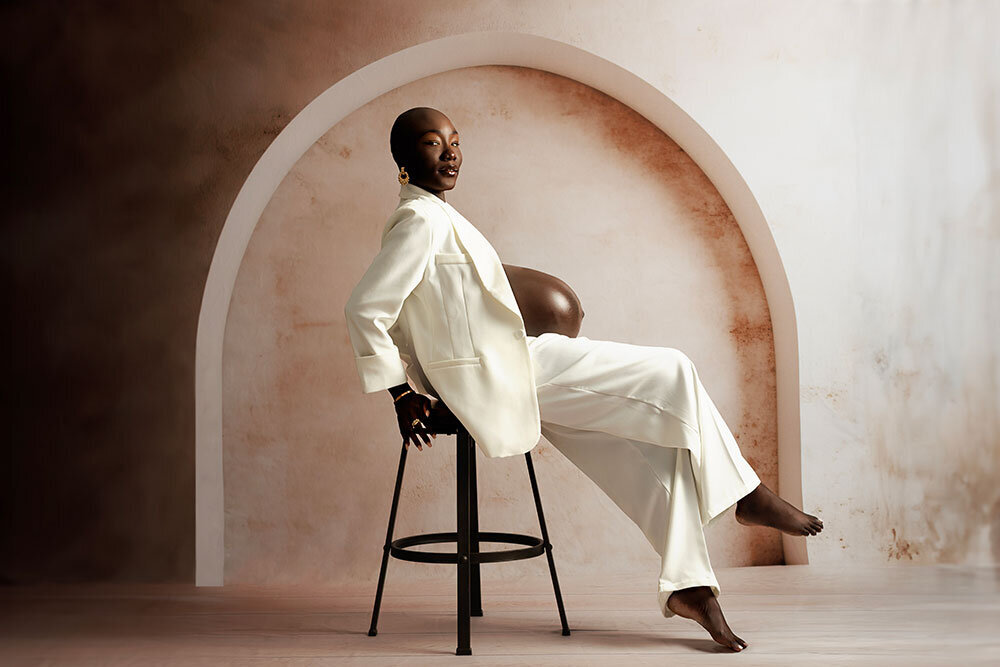 rich-bronw-studio-background-modern-refined-black-woman-pregnant-wearing-white-blazer-magazine-style