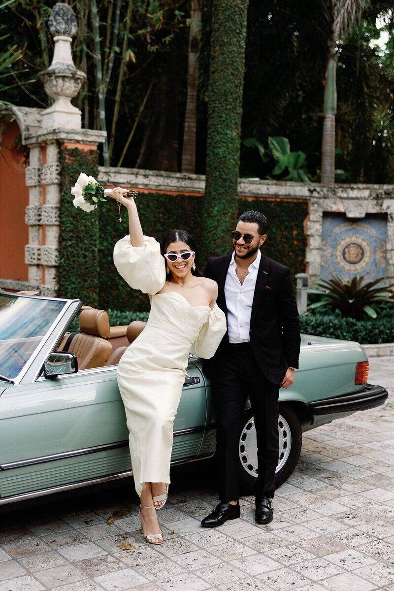 couple leaning against car, taken by surprise proposal photographer naples