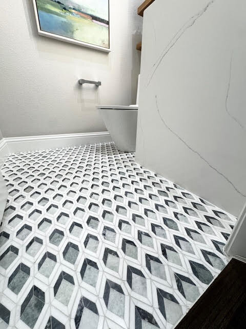 Elegant bathroom floor designed by a home remodeling and renovation consultant, featuring sleek tiles and a modern aesthetic.