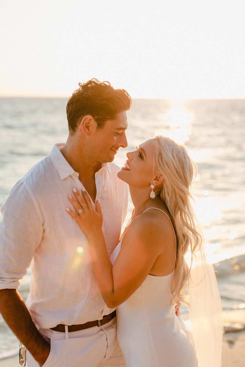 Bride looking at groom with her hand on his chest