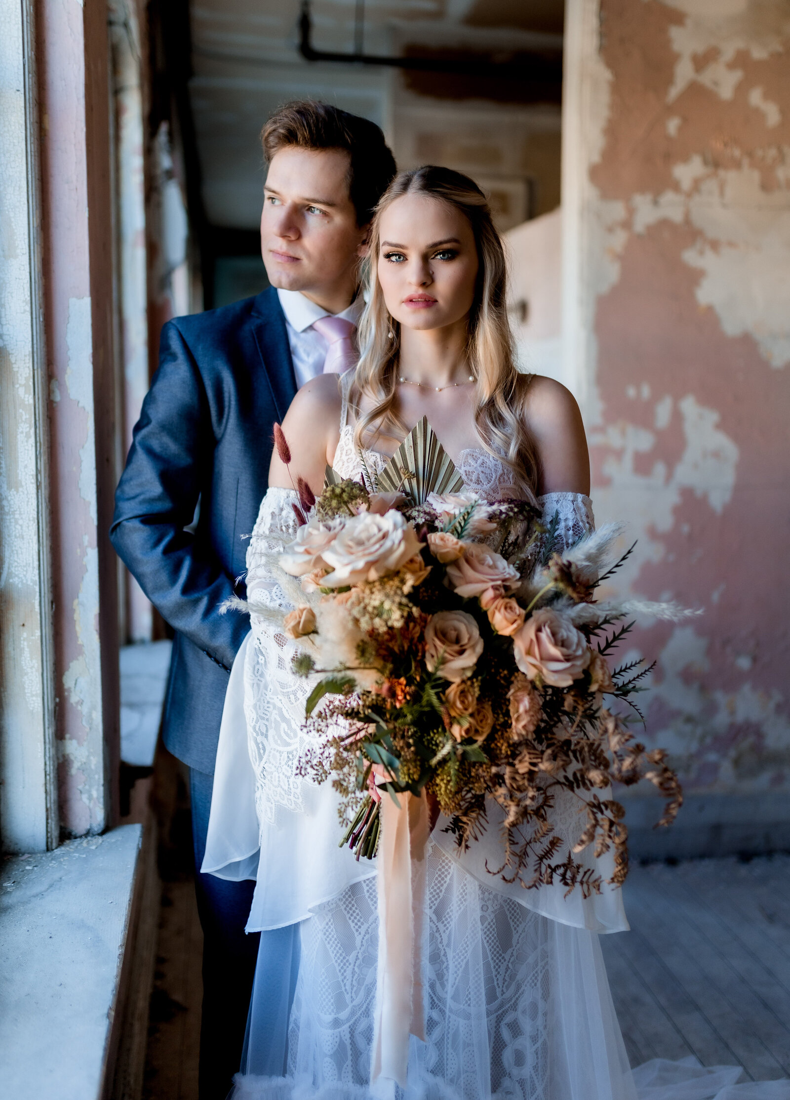 married couple with bride in the front holding. abouquet