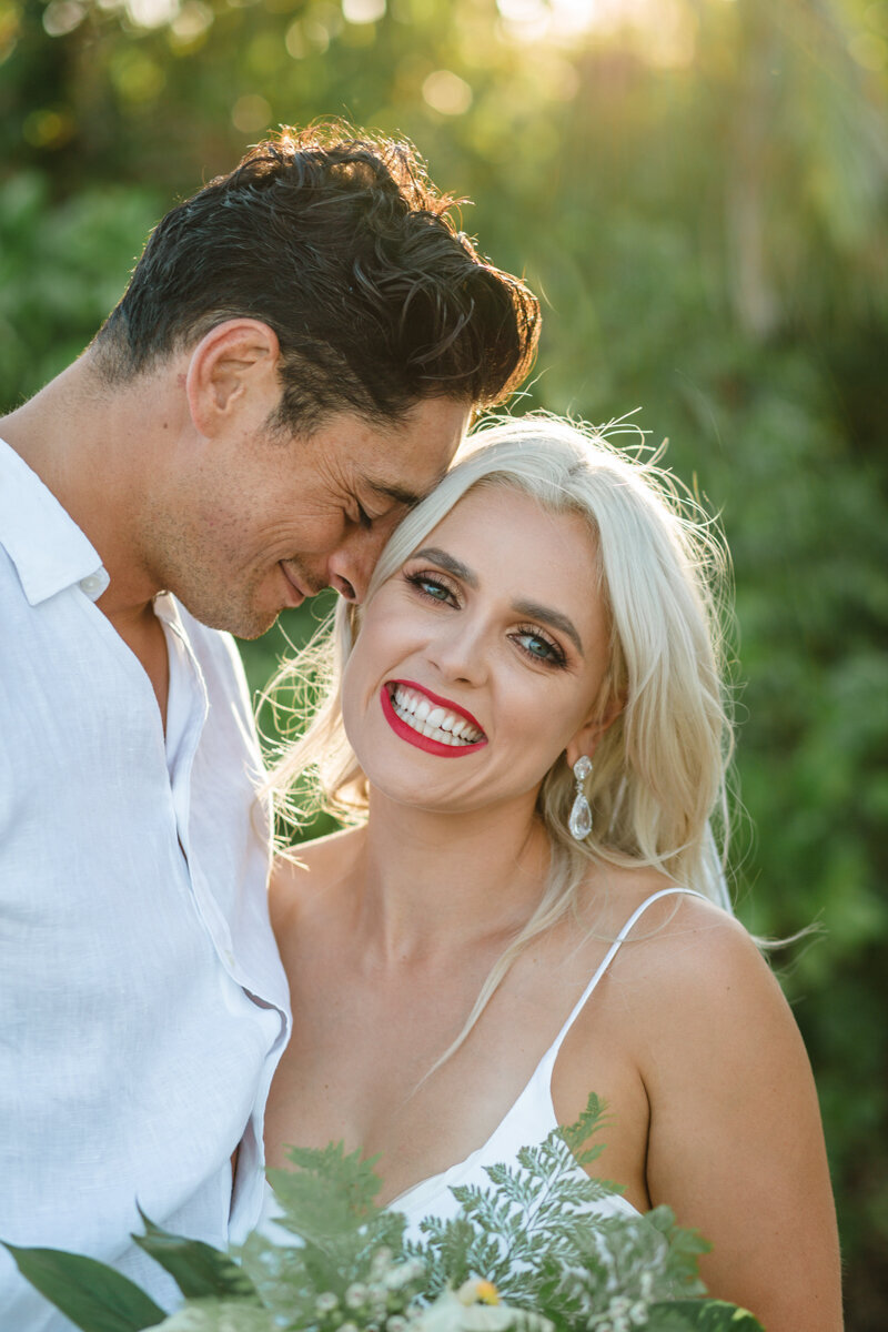 bride and groom smiling for wedding photograph