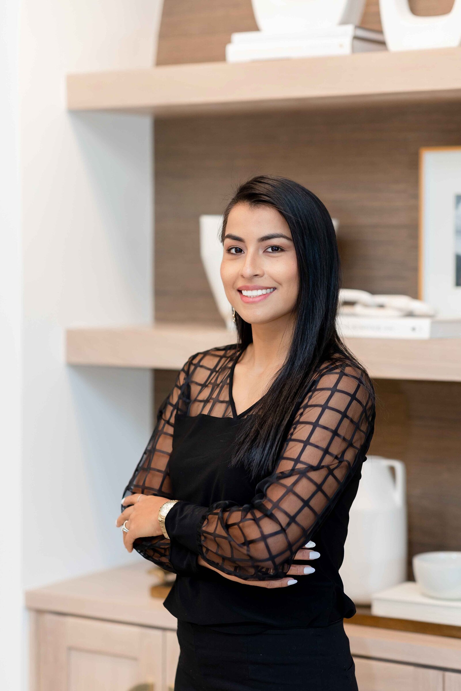 Woman smiling in front of shelf for branding photoshoot