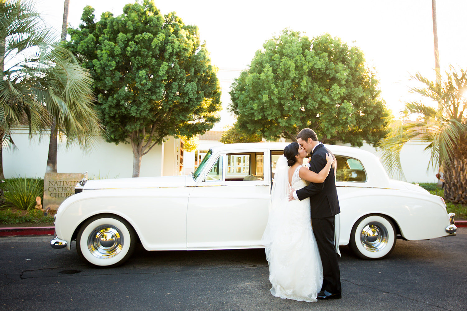 bride and groom at the crosby club beautiful light on bridge classic car