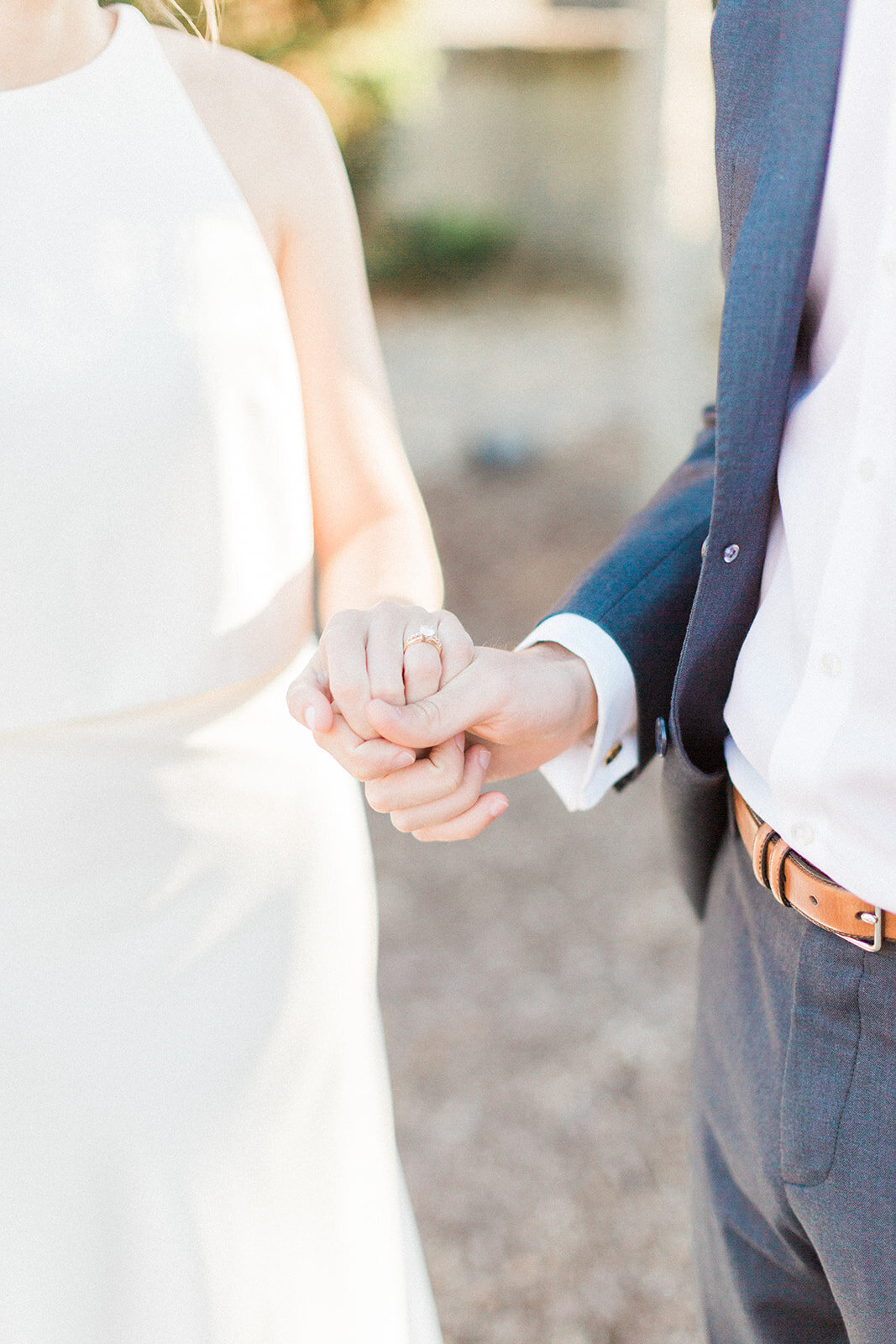 bride and groom holding hands a