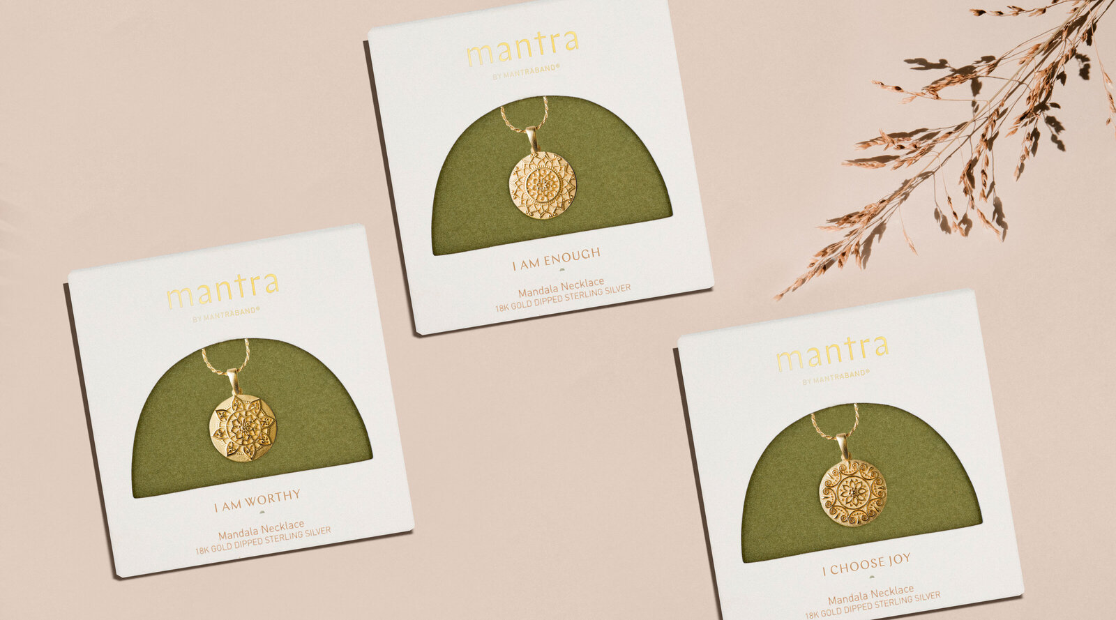Mantra by Mantraband mandala necklaces in packaging with green backing