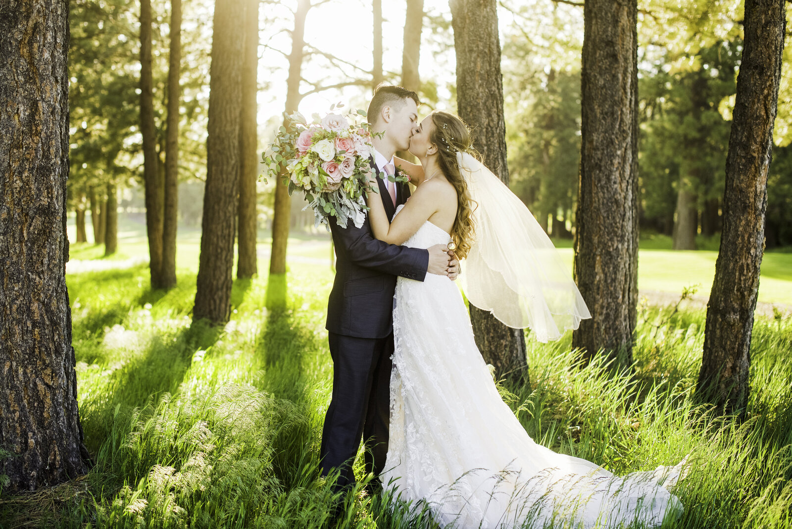 Flagstaff summer wedding bride and couple kissing pine trees sunlight
