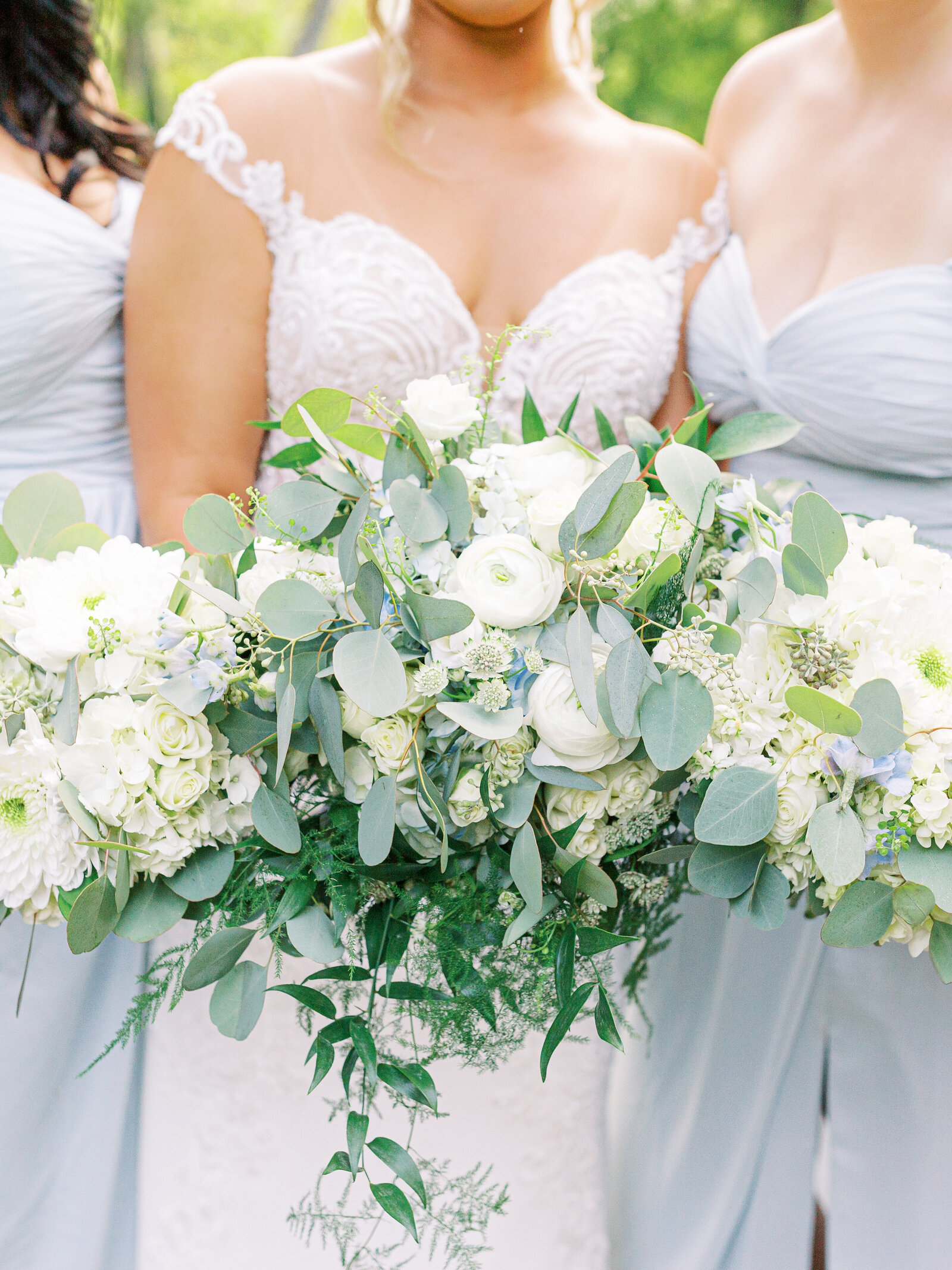white floral and greenery with light blue accent bouquets