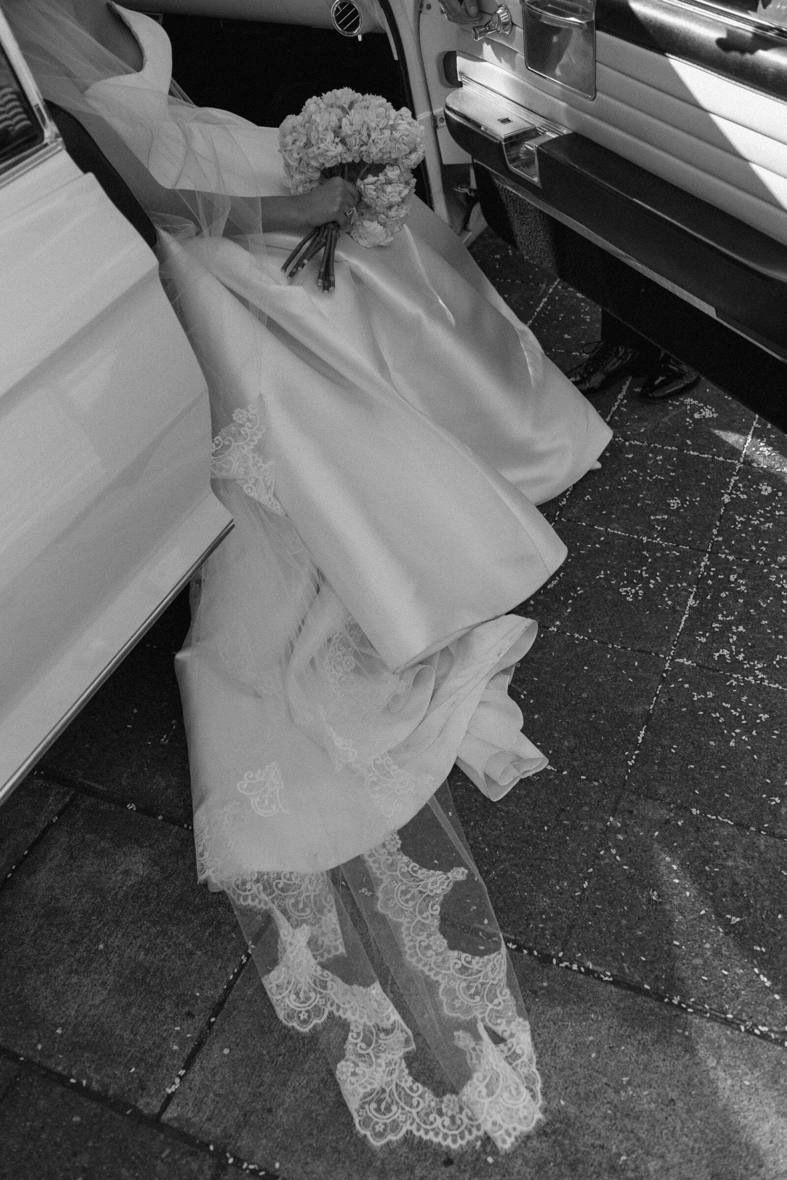 bride's veil and dress in a vintage car