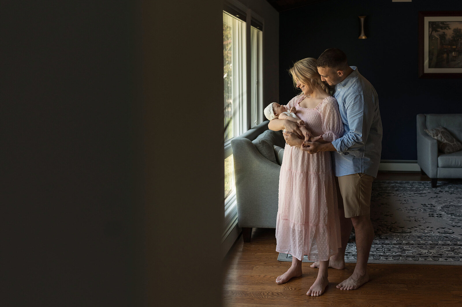 NJ Family Photographer  captures new parents looking lovingly at their new baby