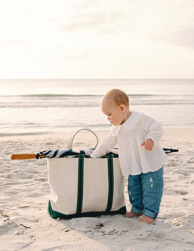 little boy searching in beach bag taken by family photographer naples fl