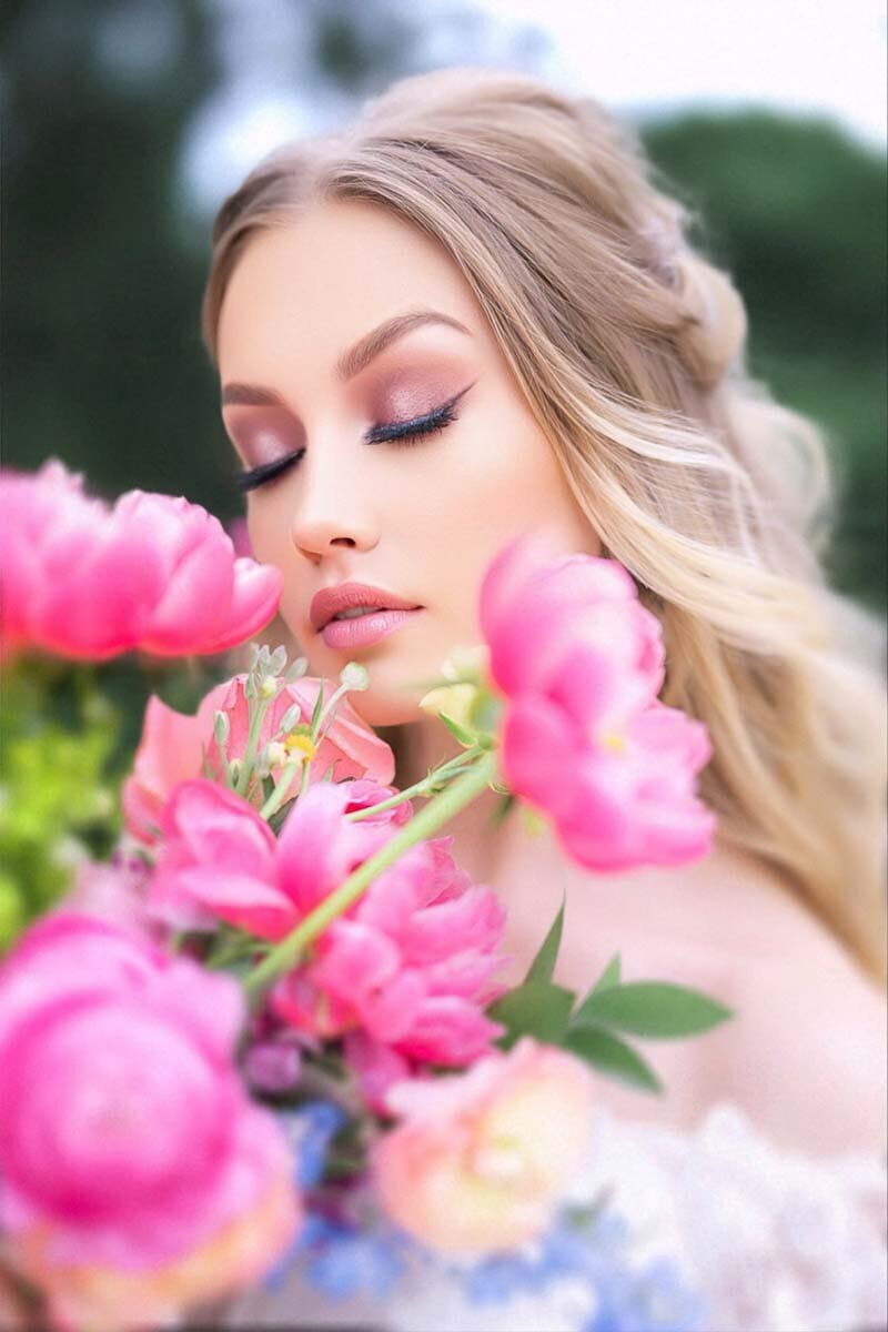 photo of bride holding bouquet showing off her makeup look