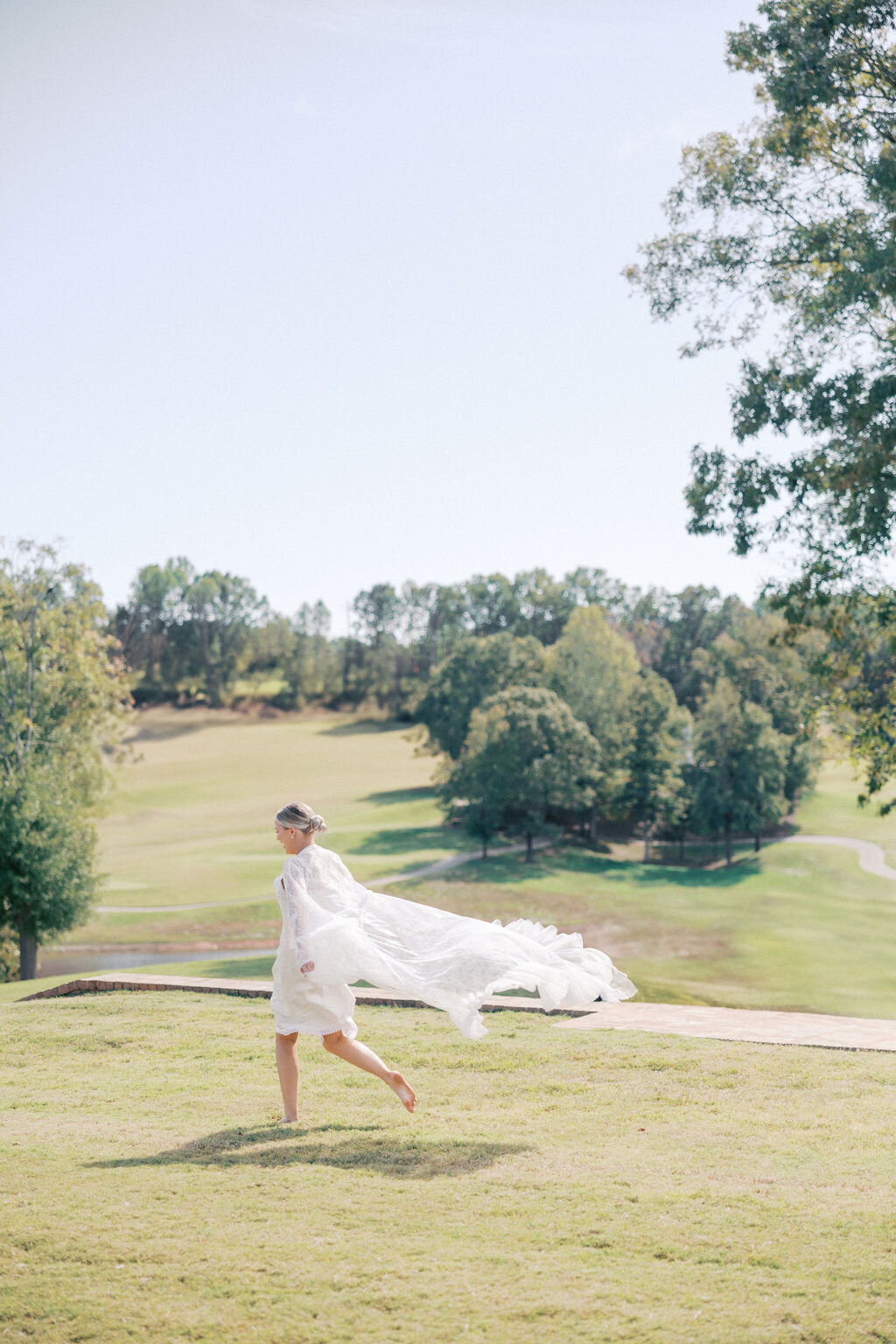 Woman in white robe runs across Chimney Oaks Golf Course