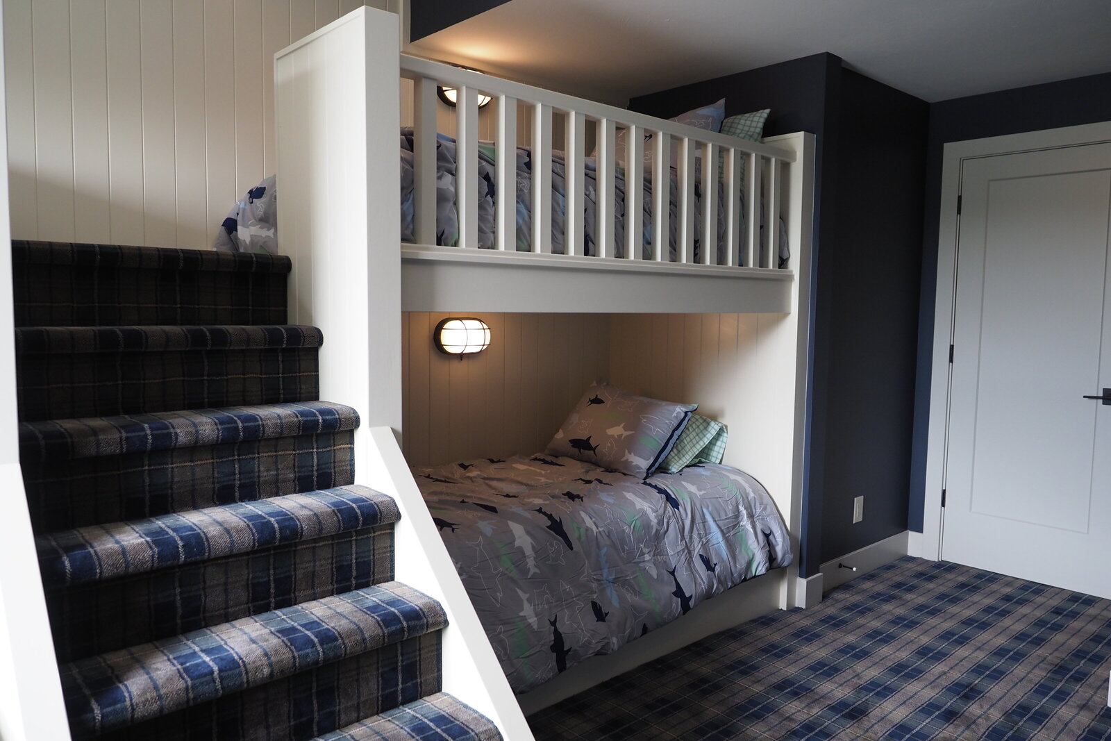 Built-in bunkbeds with steps leading up to the top tier.