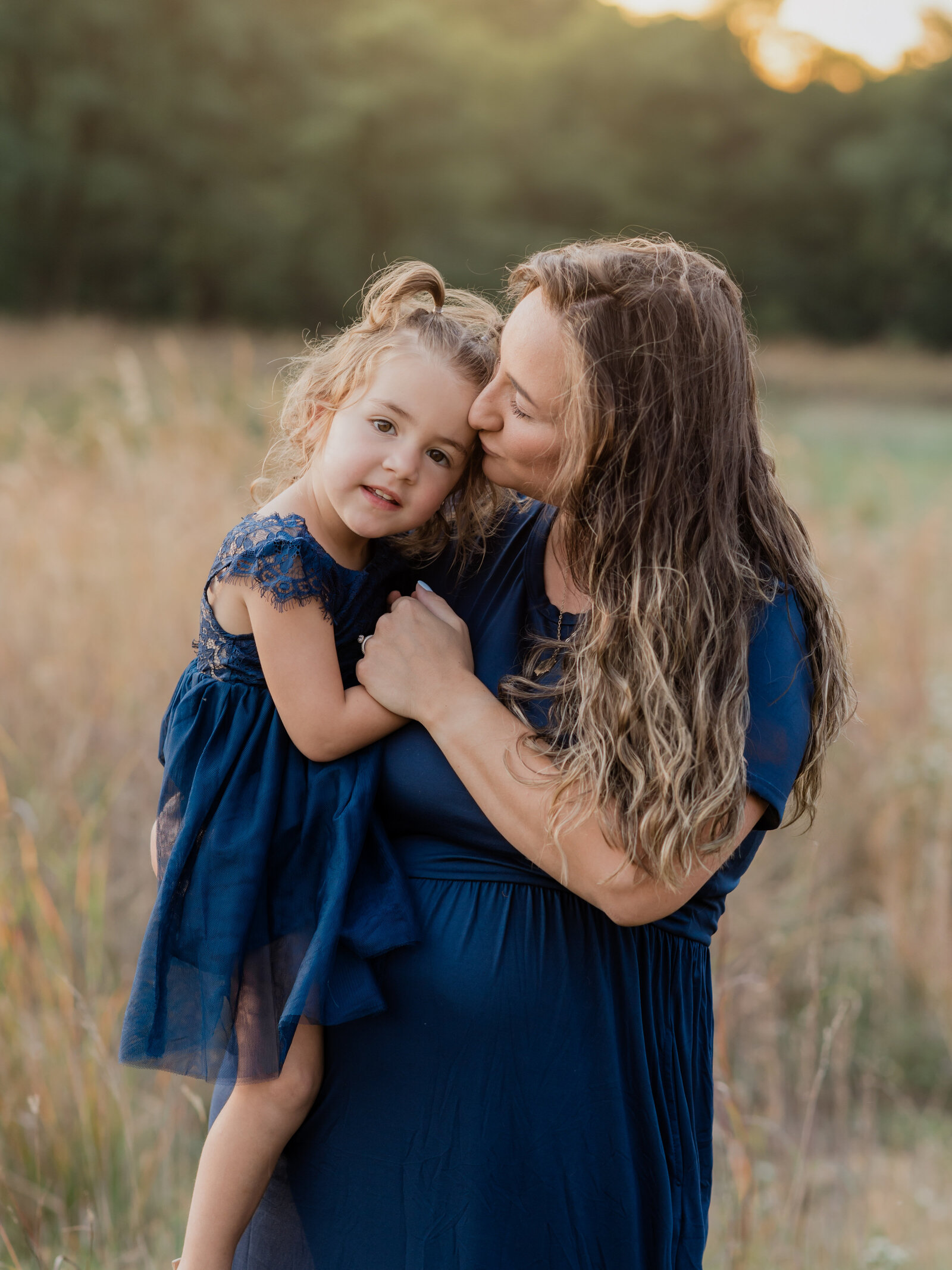 pregnant mother holding daughter for maternity photos cleveland maternity photographer