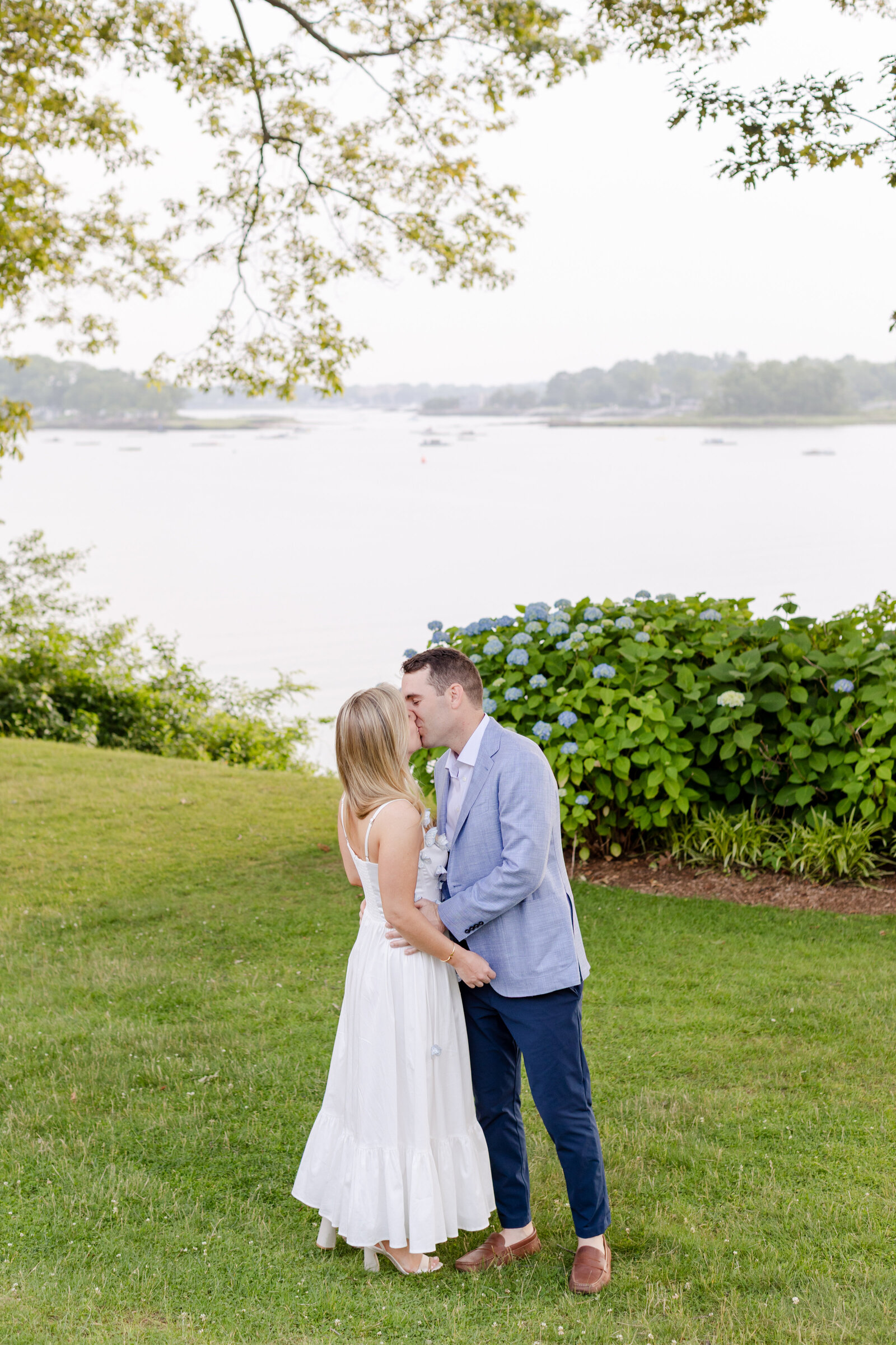 Couple kissing during portraits session of the Rehearsal Dinner at Wainwright House, Rehearsal dinner on the lawn of Wainwright House the night before their wedding