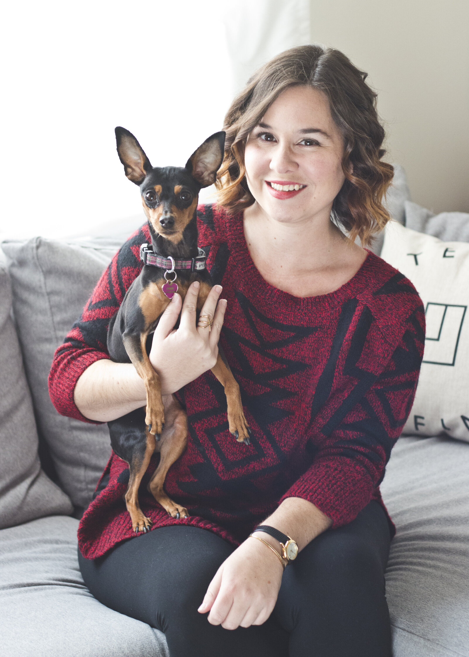 woman headshot with dog on couch