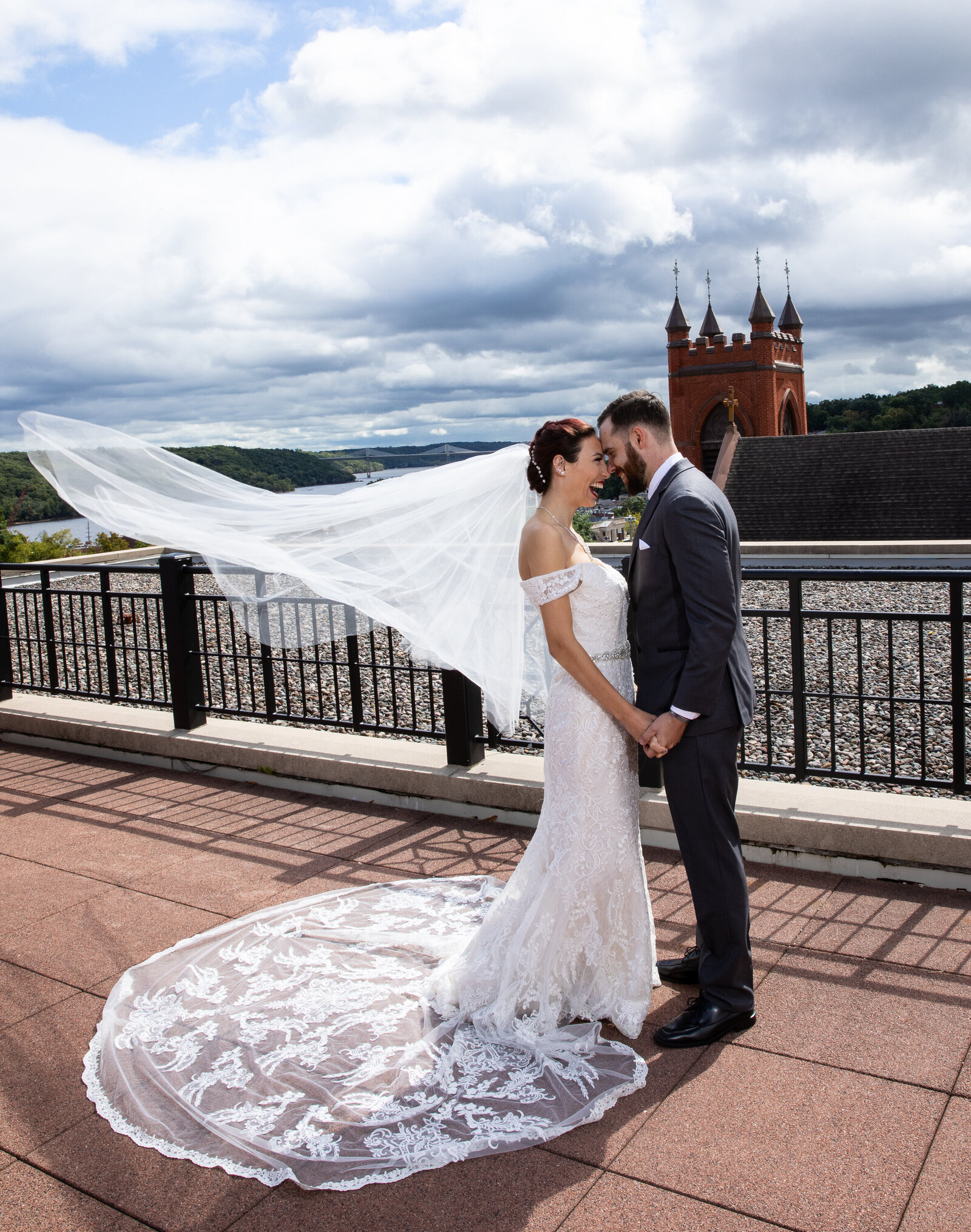 Wind in Bride's veil with Groom Rooftop wedding