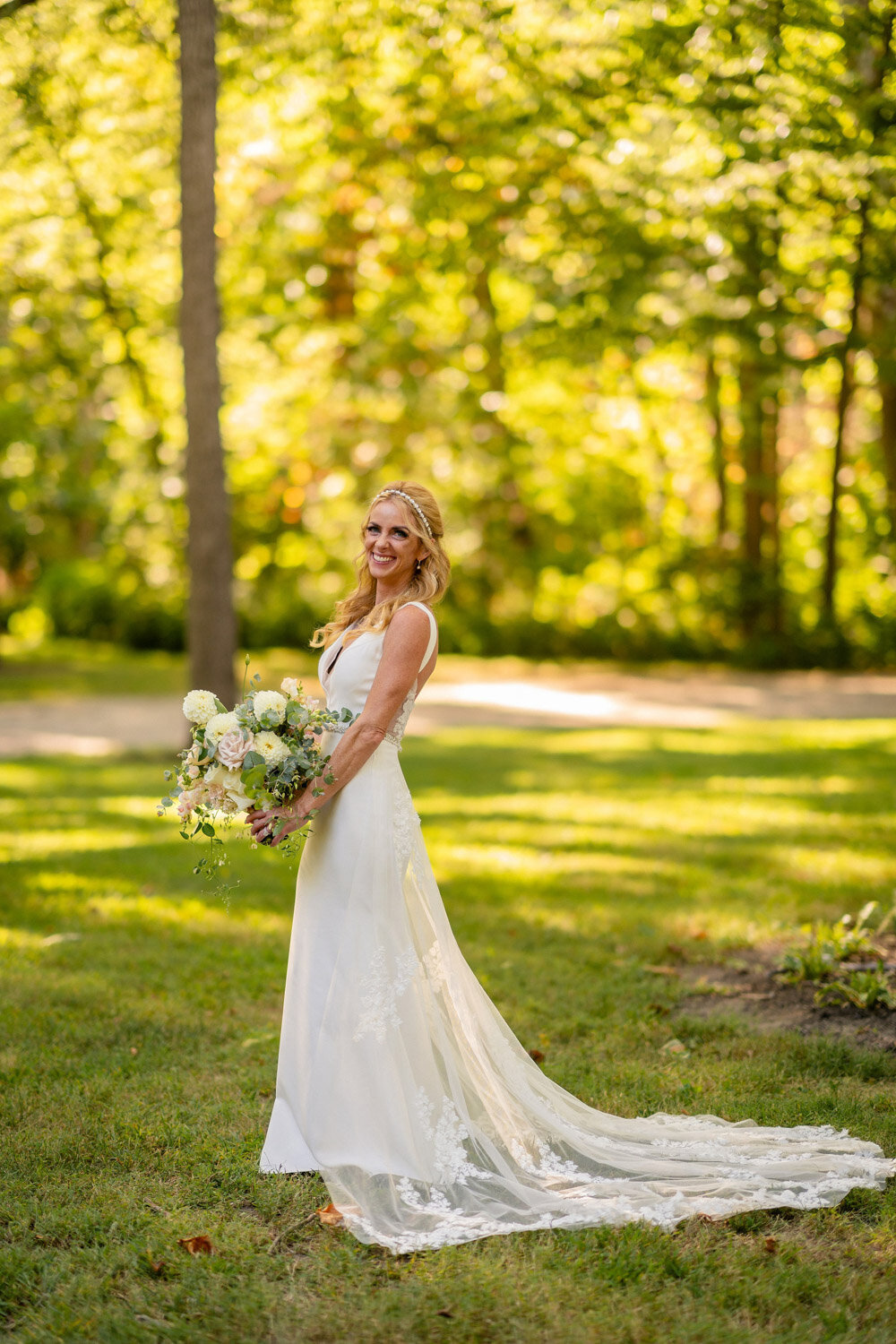 Smiling bride walking in greenery field