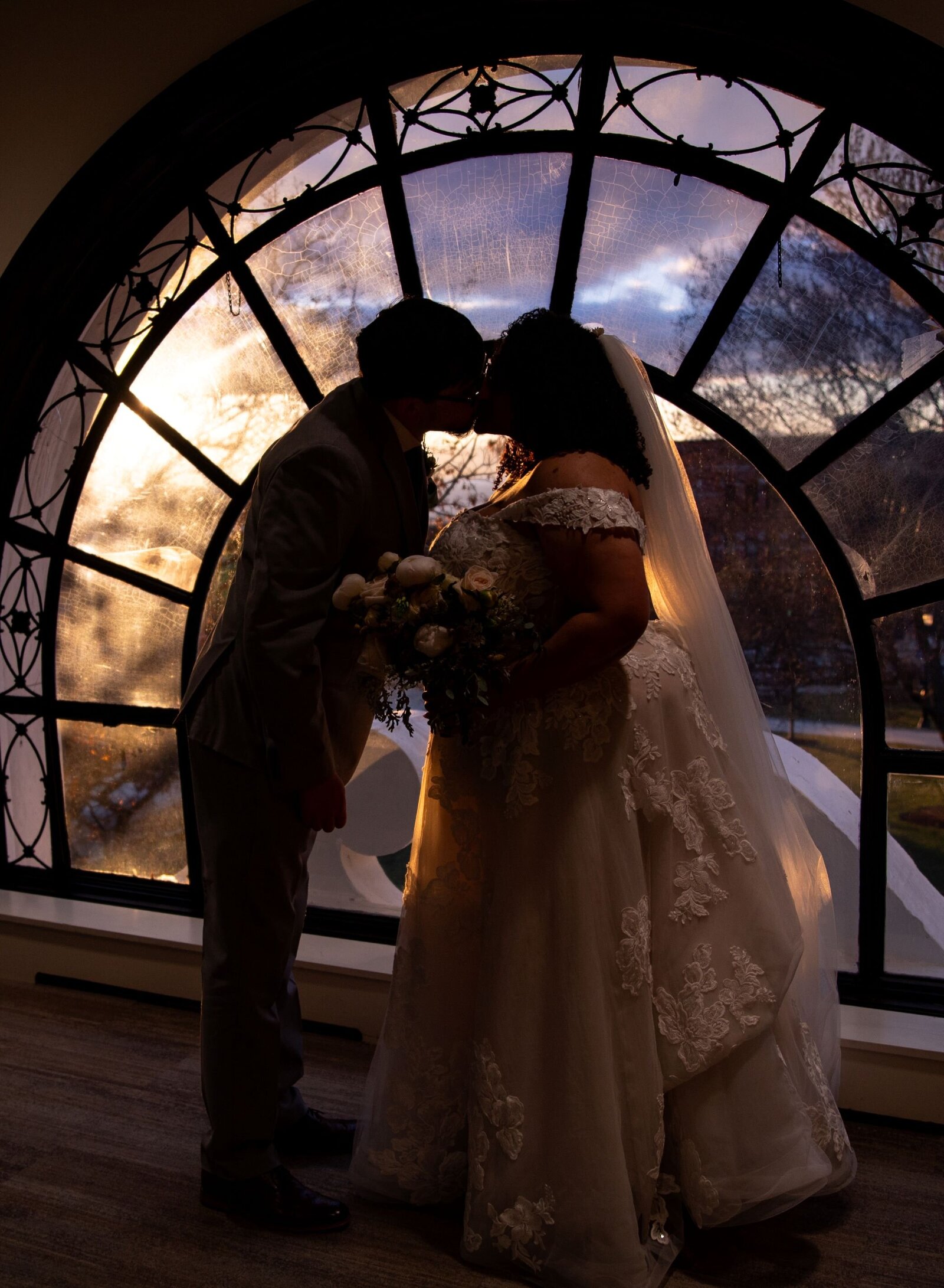 couple kissing inside Burlington city hall at sunset