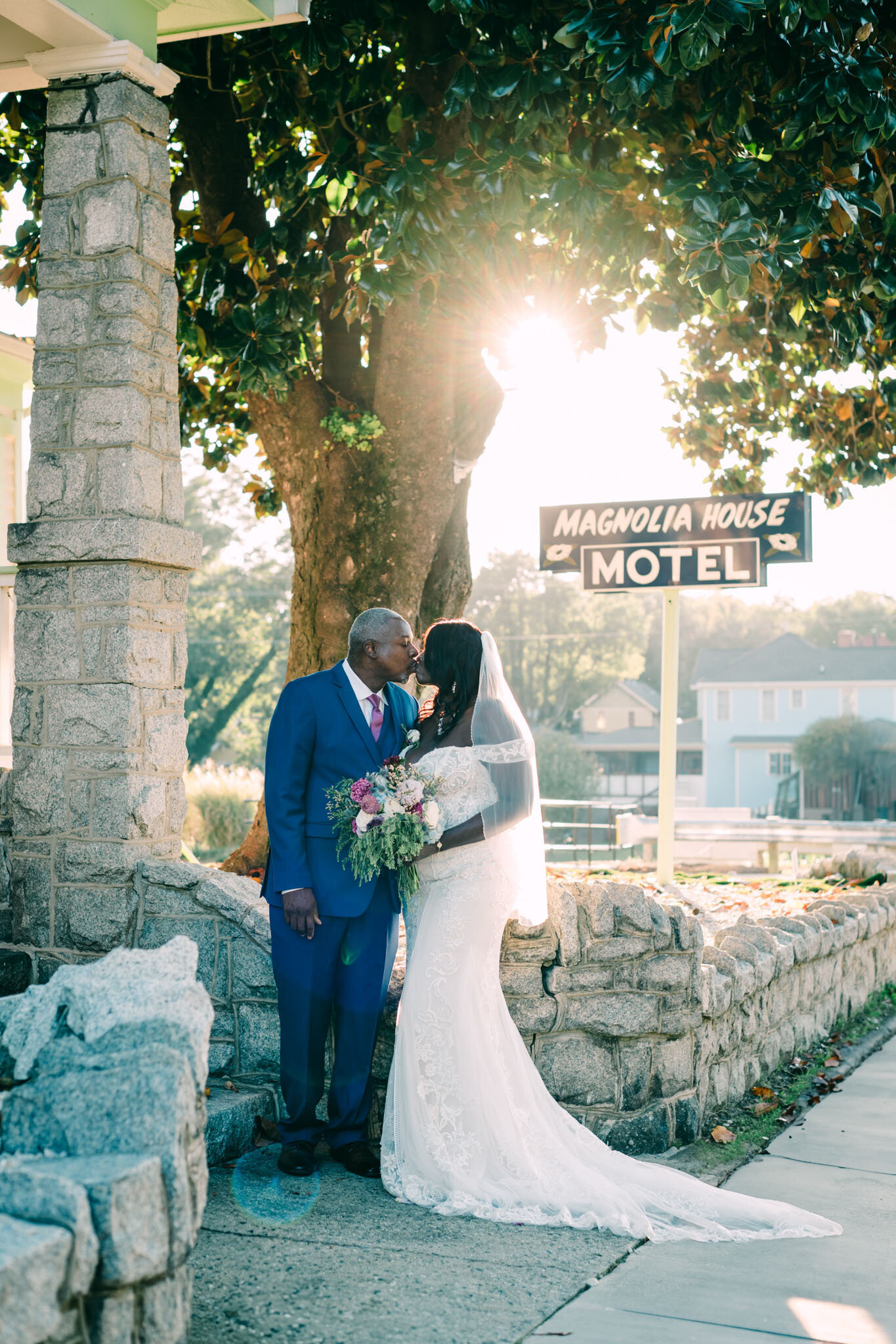 bride and groom kissing in an outdoor setting
