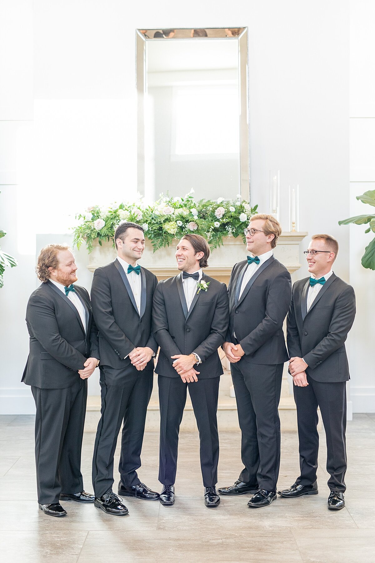 Groom and groomsmen in black suits and bow ties in Encinitas by Sherr Weddings.