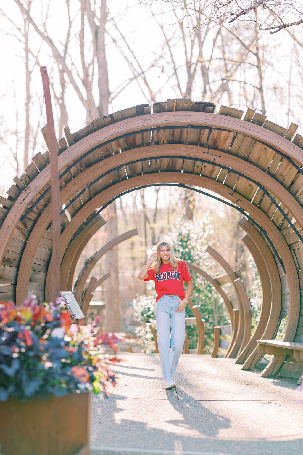 Girl walks under barrel arch at Athens Botanical Gardens