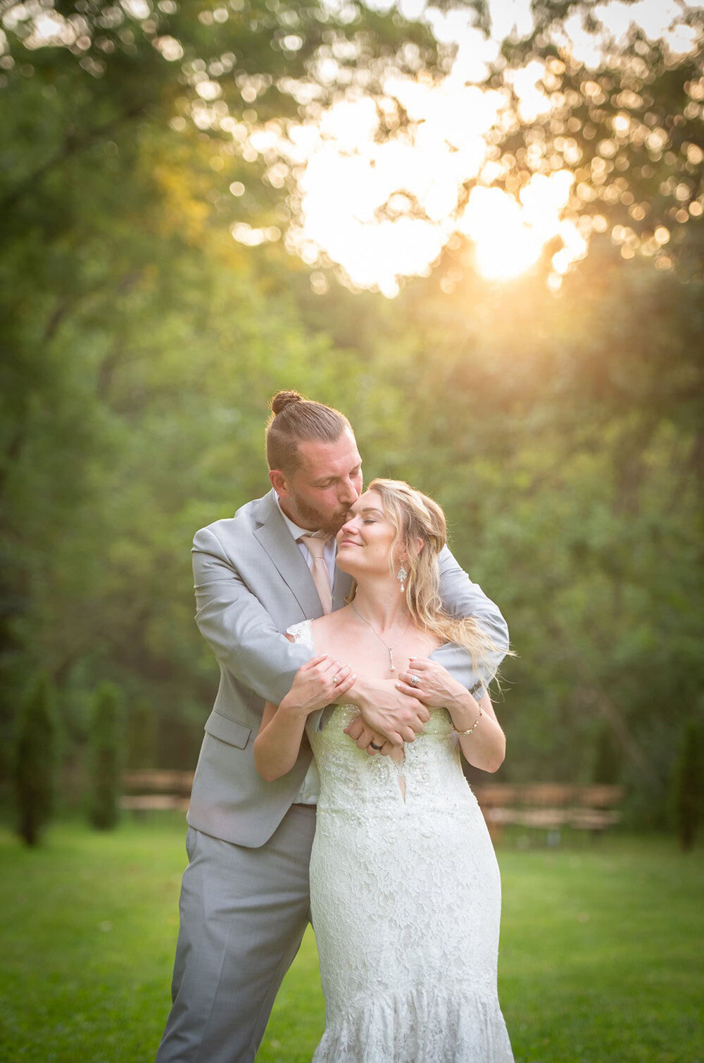 groom hugs bride from behind