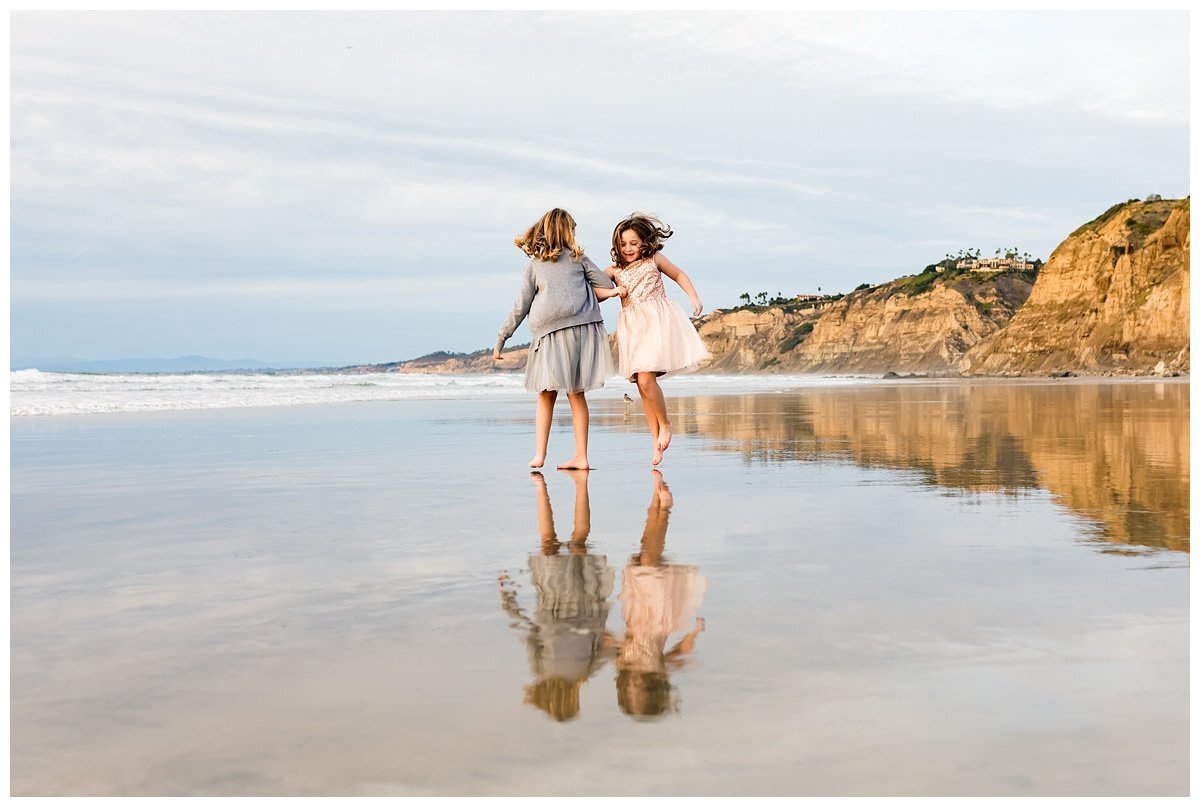 sisters dancing on the beach in San Diego