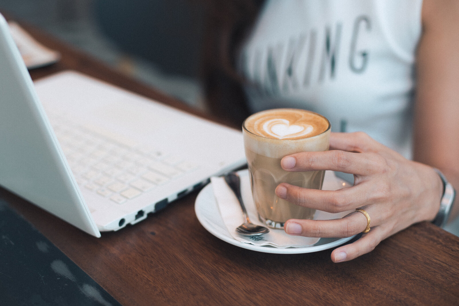 Canva - Close-up of Woman Holding Coffee Cup on Table
