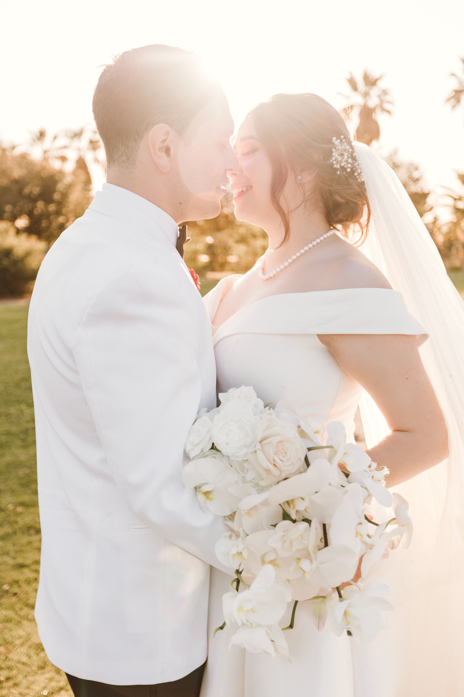 Newlyweds share an intimate moment at the top of a hill at Hillcrest Park in Fullerton California