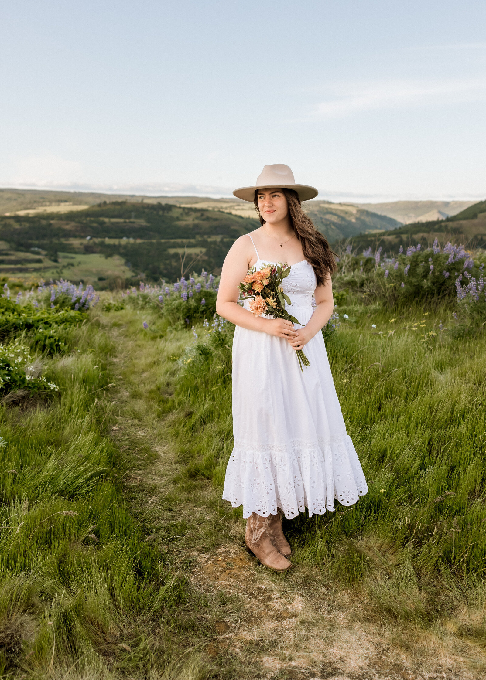 Girl walking through a field of wildflowers.